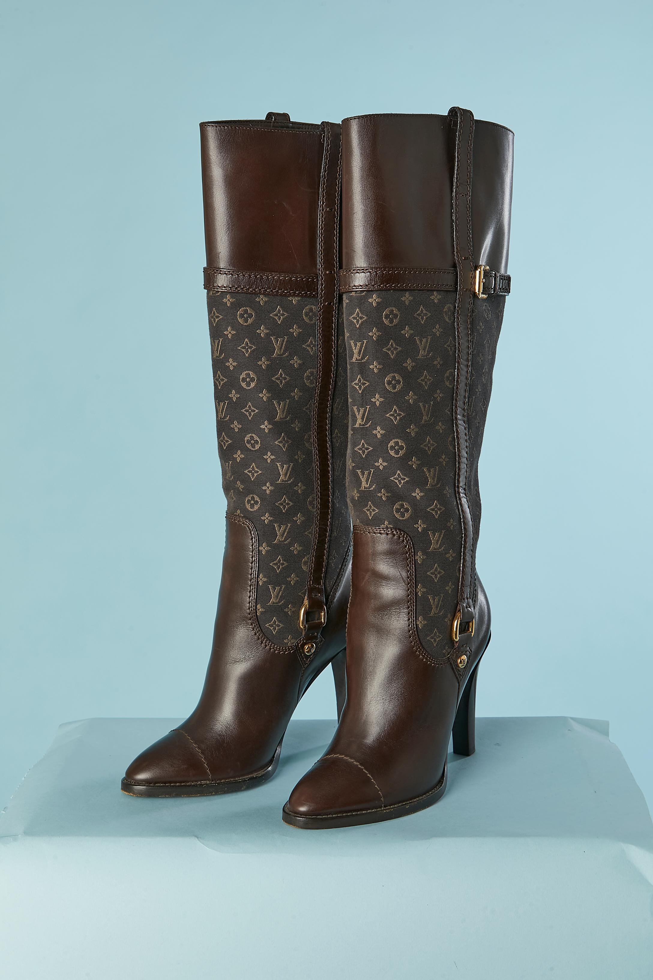 Brown leather and Monogram canevas. Gold metal hardware. 
Heels height : 10cm 
Platform height: 0,8 cm 
Total height : 46 cm 
Leather belt and buckle on the top part of the boots. Branded studs. 
SHOE SIZE : 36 (It) 5 (Us) 
