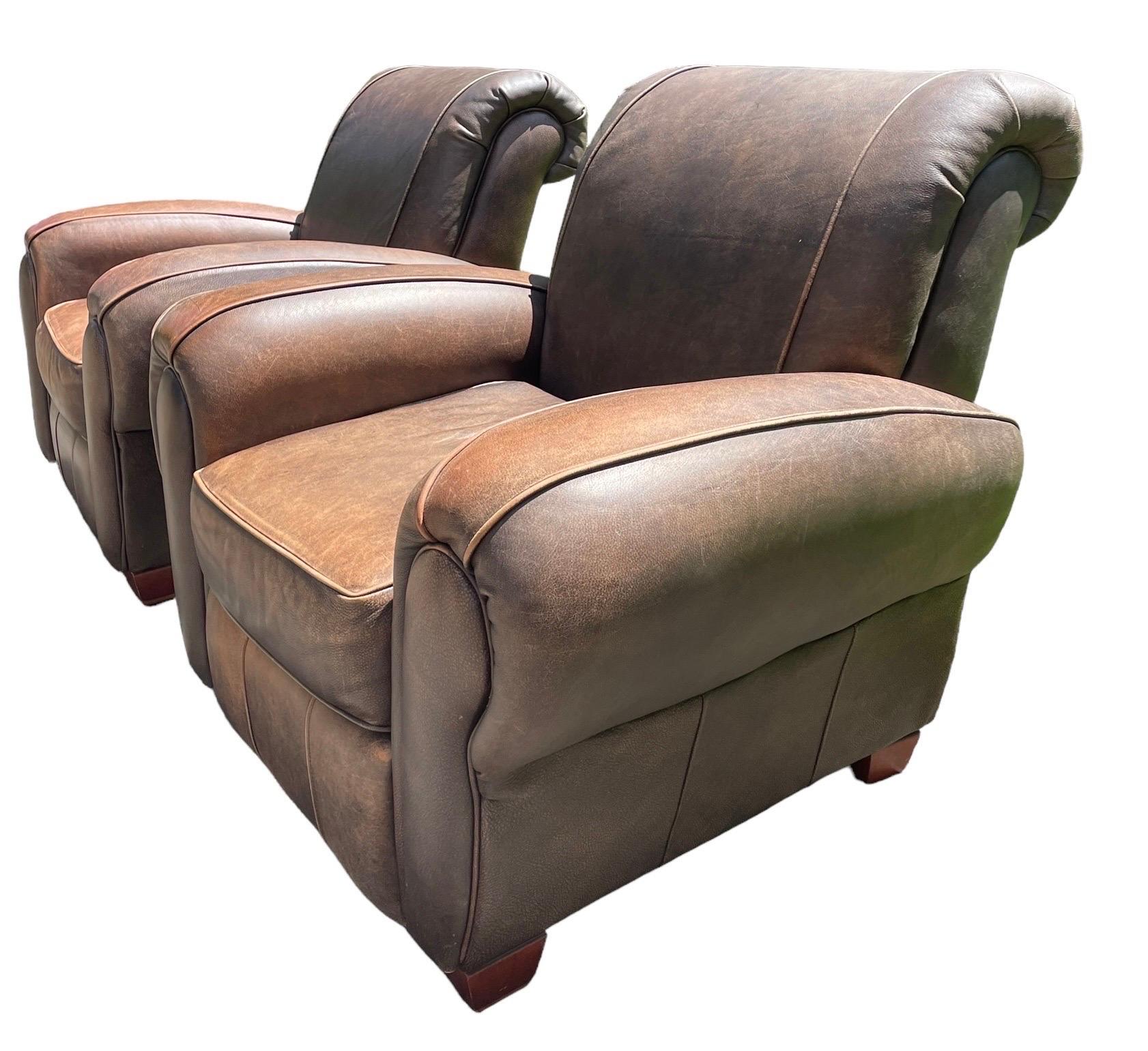 Pair of deep wide substantial reclining leather club chairs in the classic cigar arm style. Top tier quality, incredibly comfortable soft leather. The generous arm rests and back have a “sink into me” level of comfort. All leather is original and in