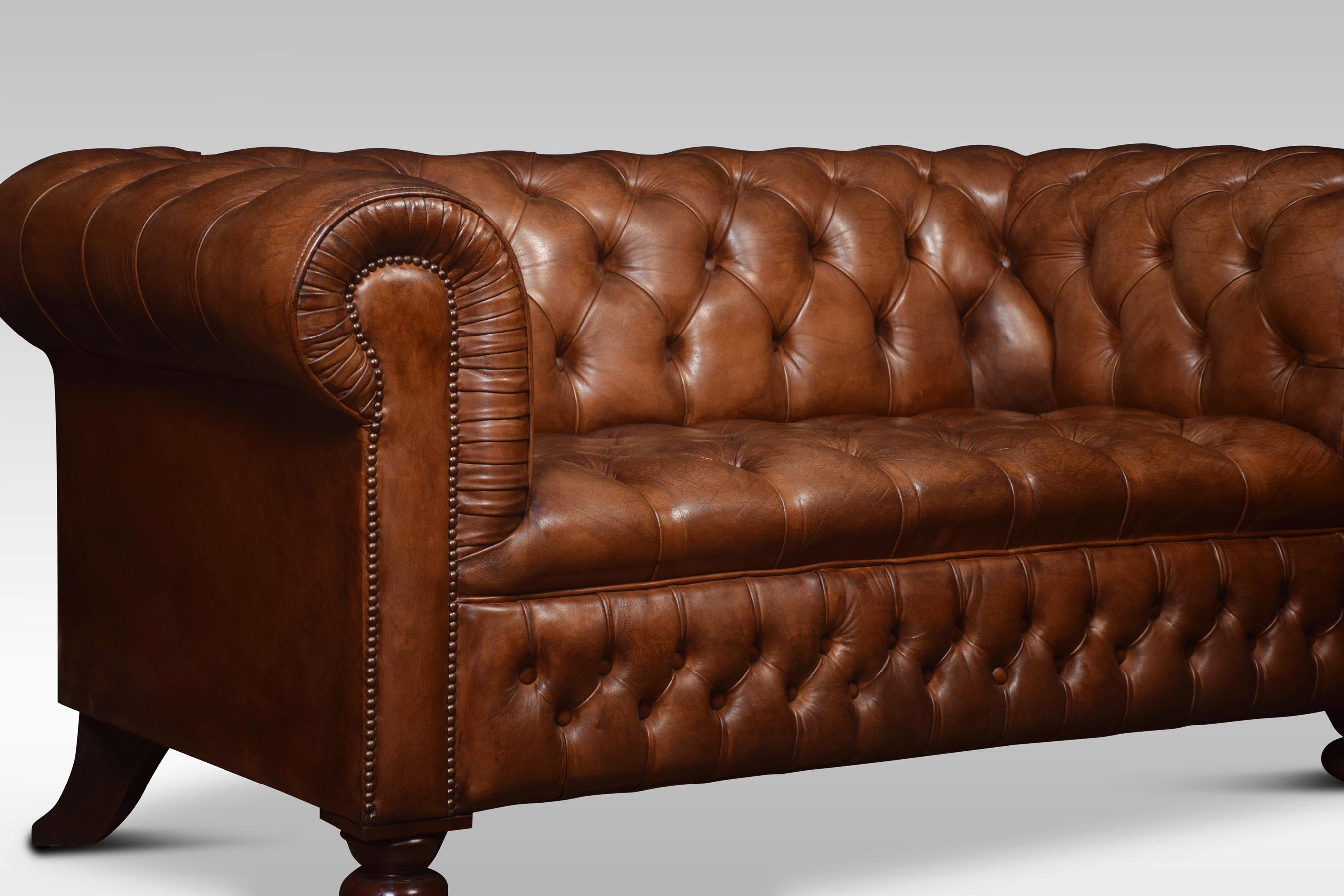 Two-seat brown leather chesterfield sofa, having deep buttoned back and seat, raised up on turned feet with brass castors. Good solid condition, the leather is soft, nicely worn in.
Dimensions
Height 32 inches height to seat 19 inches
Length 65