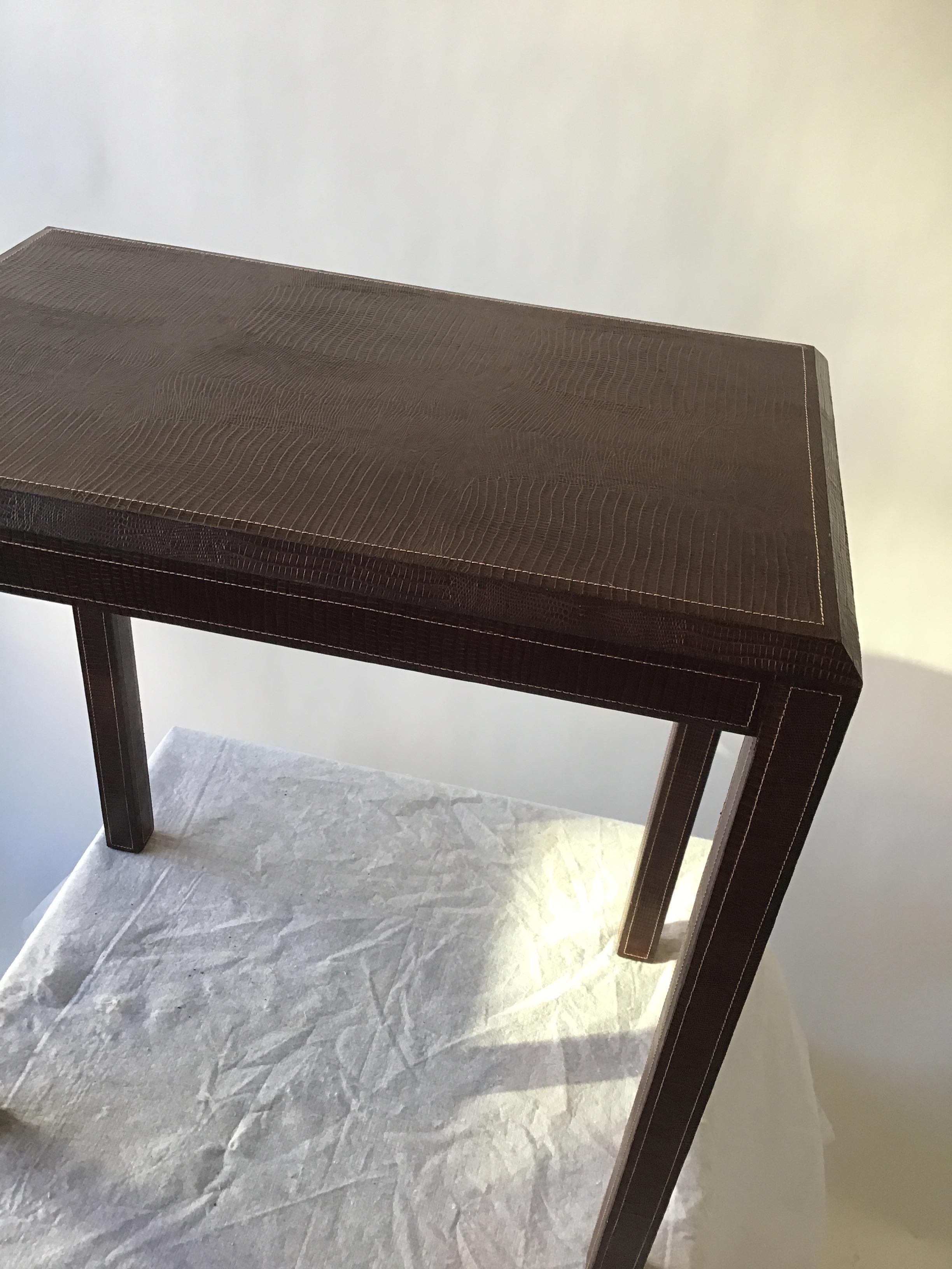 Brown leather embossed lizard side table with top stitch.
