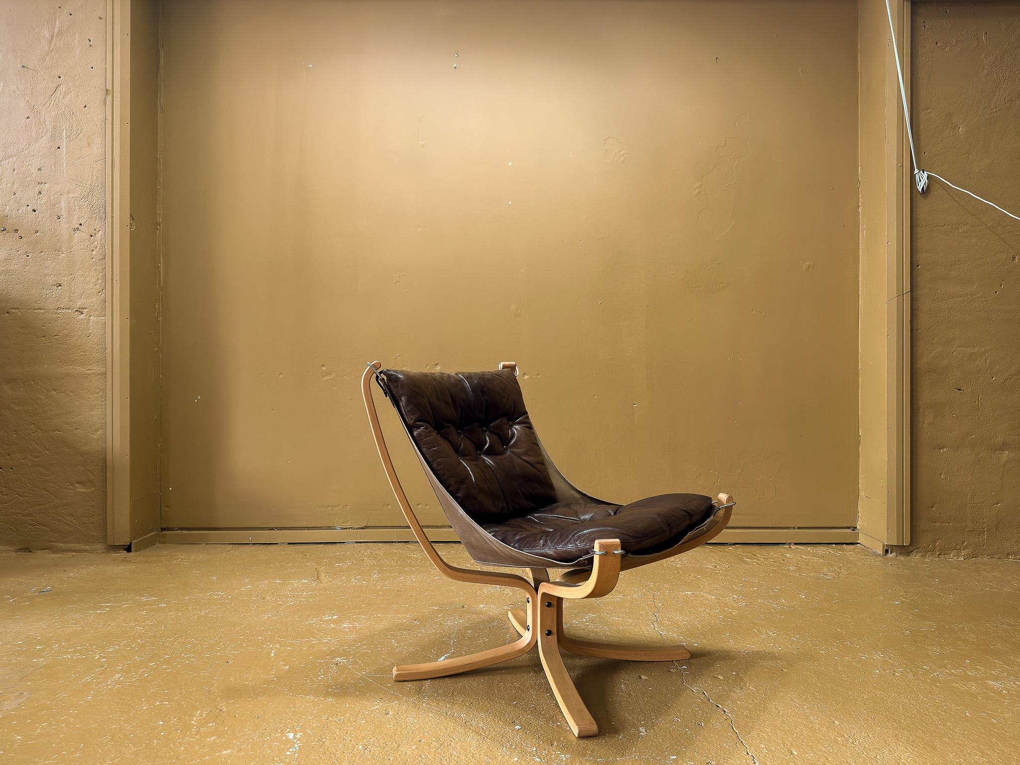 Iconic armchair designed by Norwegian designer Sigurd Ressell. Designed in 1970, with its solid beech frame, canvas sling, chrome hardware, and rich brown leather upholstery, this model was produced by Norwegian furniture manufacturer Vatne Møbler.