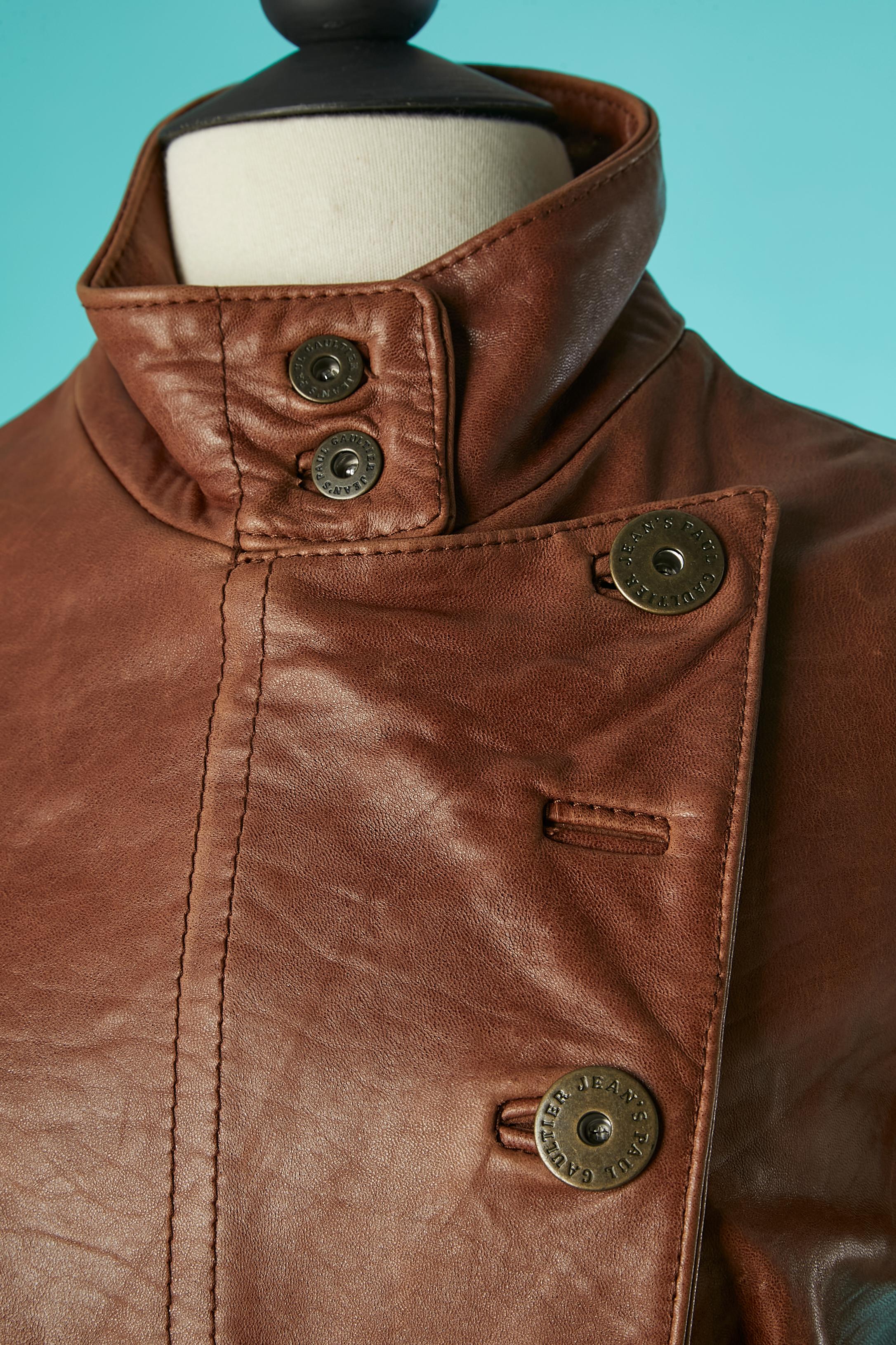 Brown leather jacket with branded buttons and zip closure in the middle front. Leather is genuine ovine leather. Padding and printed lining : 100% polyester. 
There is 7 buttonhole and 4 buttons in the middle front but it's main to be this way ( 3