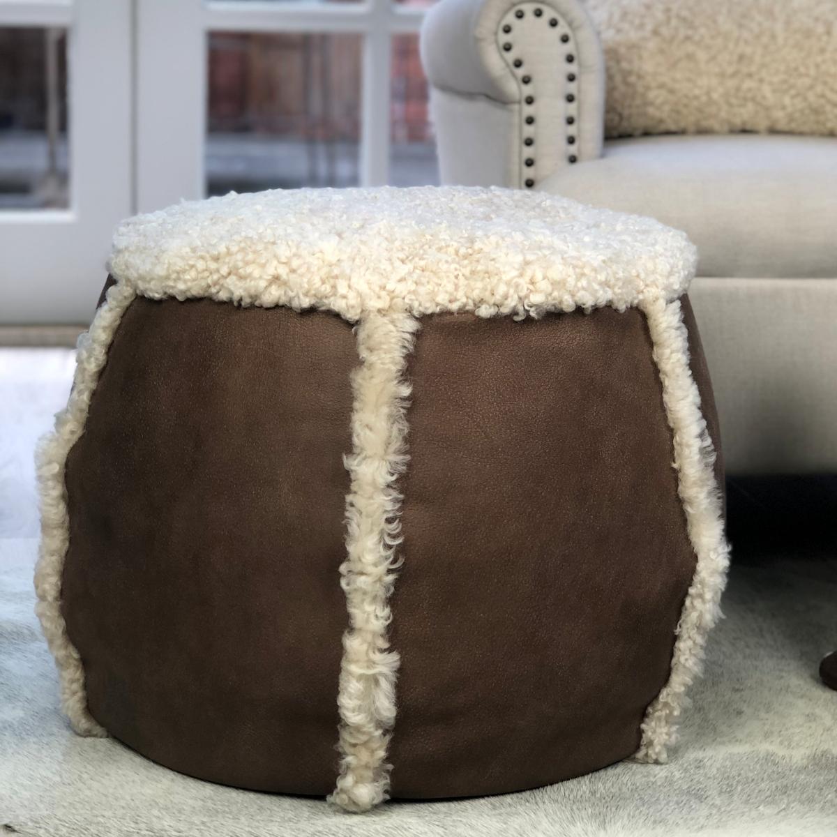 What a great way to add a stylish addition to your living room comfort with this brown leather pouf. Featuring an Italian grained leather trimmed with Australian curly wool shearling sheepskin complimenting the leather pouf's comfort