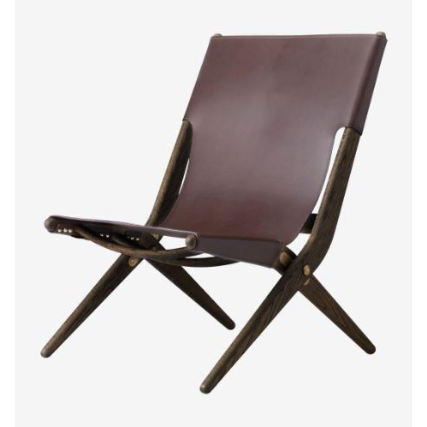 Brown leather saxe chair by Lassen
Dimensions: D 67 x W 60 x H 84 cm 
Materials: leather, wood, brown oiled oak
Also available in different colors and materials. 
Weight: 13 Kg

Mogens Lassen was perceived as ‘the naughty boy in class’, but he