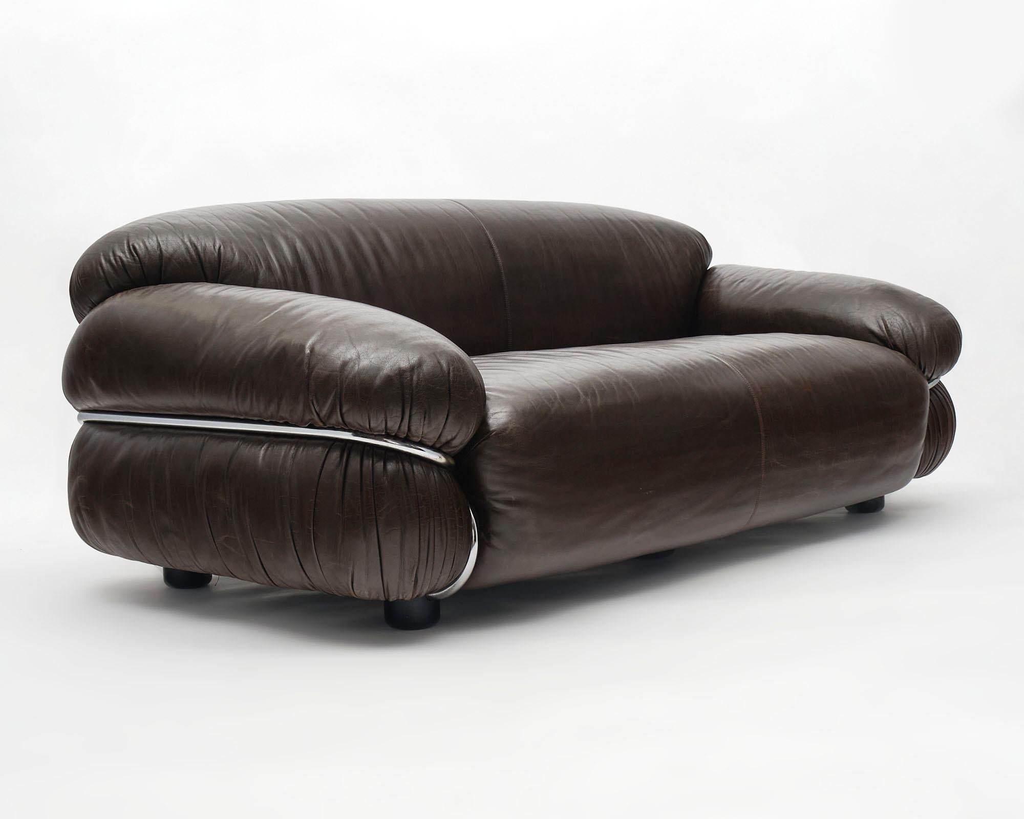 Italian sofa, by Gianfranco Frattini for Cassina. The supple leather, in great condition, lends itself to the voluptuous form. This sofaa rests in a bent tubular chromed structure that is in great condition.