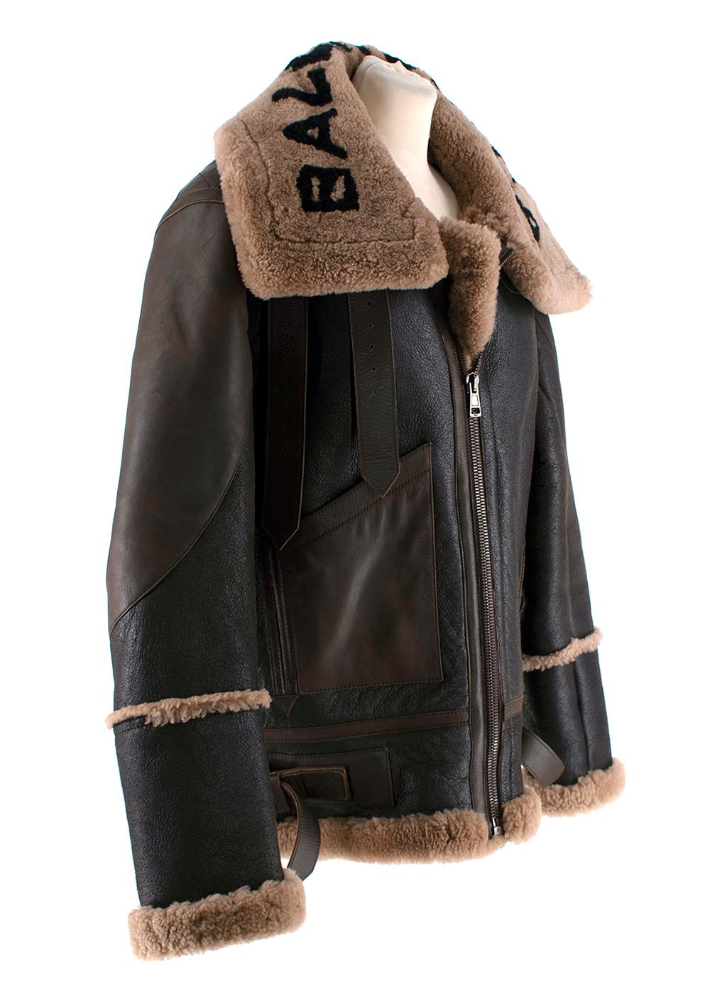 Balenciaga Brown Leather & Shearling Logo Aviator Jacket

- Iconic aviator-style jacket in brown hues
- Cracleque leather exterior with shearling-lined interior and wide lapels 
- Logo in black across the collar
- Front zip closure 
- Front patch