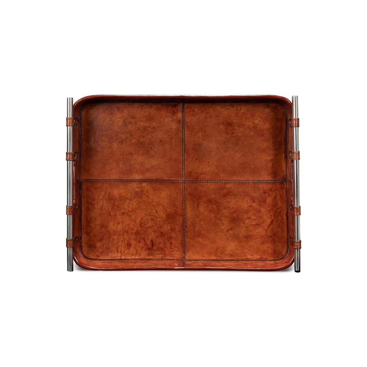 With Tobacco brown leather, this leather tray is fraught with detail: the topstitching of each leather panel, the narrow leather straps that hold the stainless steel handles in place. 

Dimensions: 19