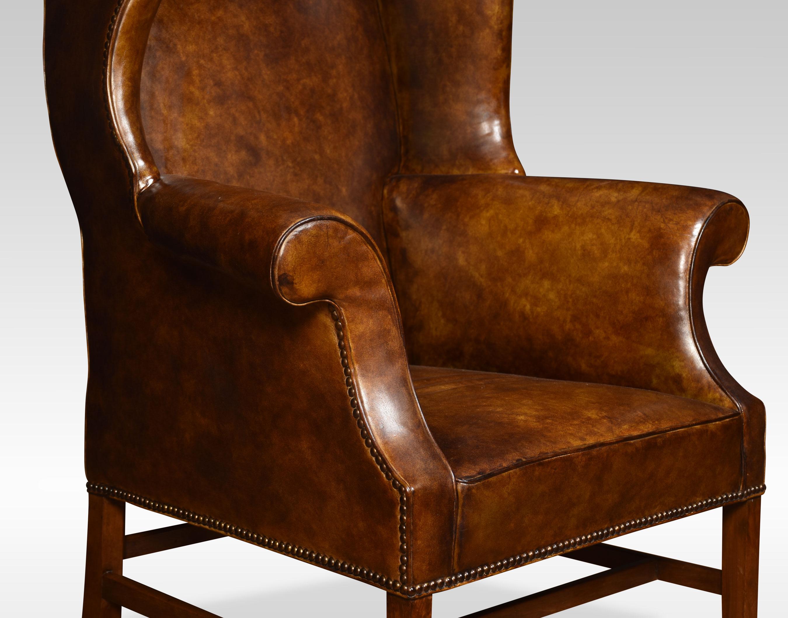 Mahogany framed wing armchair of generous proportions, the shaped top above upholstered back, arms and seat in brown leather, raised up on square supports united by stretchers.
Dimensions
Height 47.5 Inches height to seat 17.5 Inches
Width 35.5