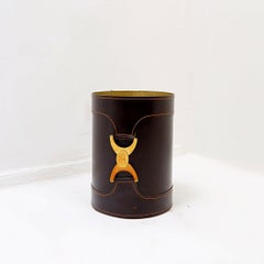 Brown leather wastebasket with a decorative brass buckle