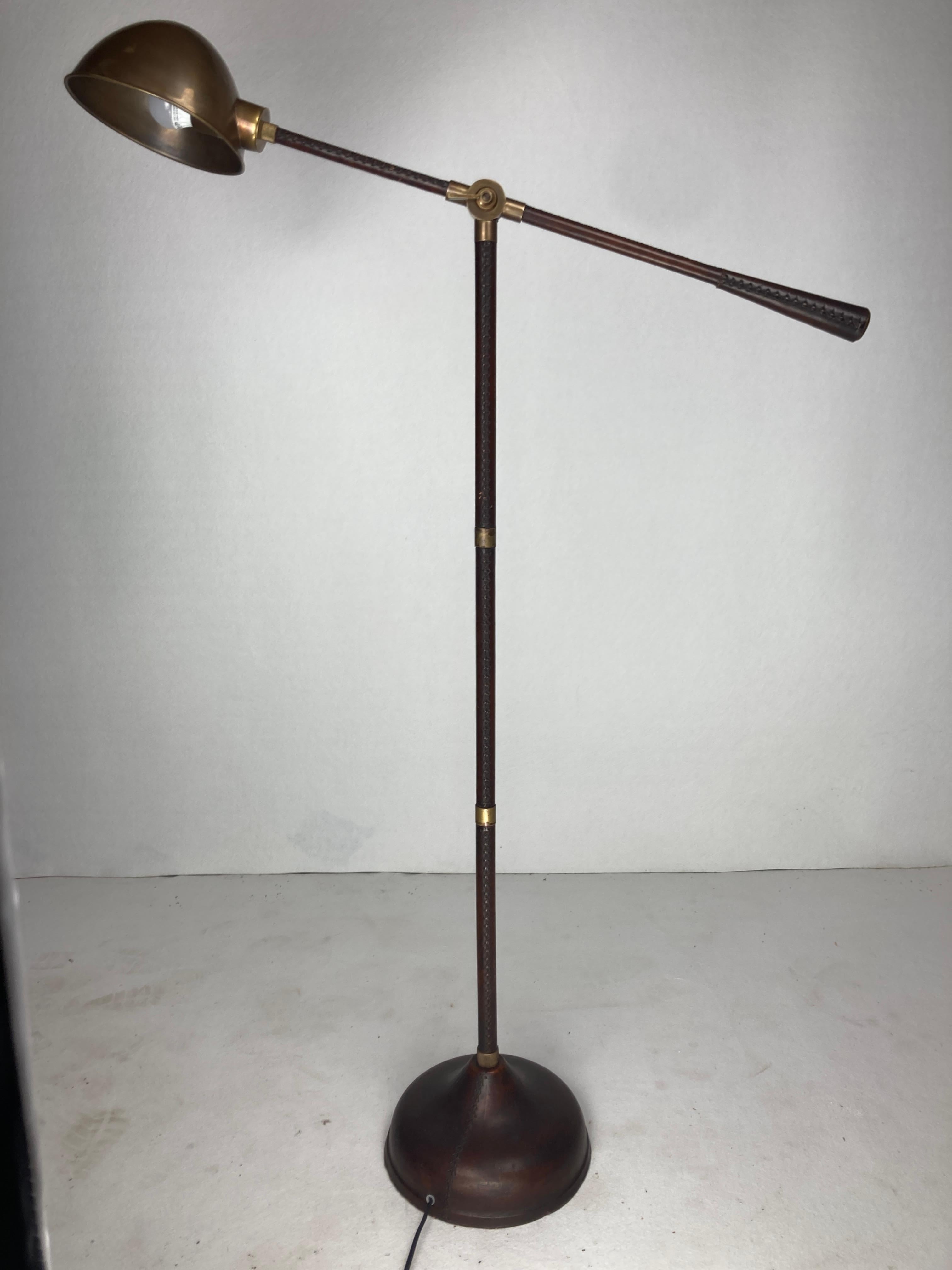 Remarkable leather wrapped and stitched floor lamp which is often named in the style of Jacques Adnet who amongst others was famous for his work with leather and also very reminiscent of the leather lamps made by Valenti. Although it came to us as