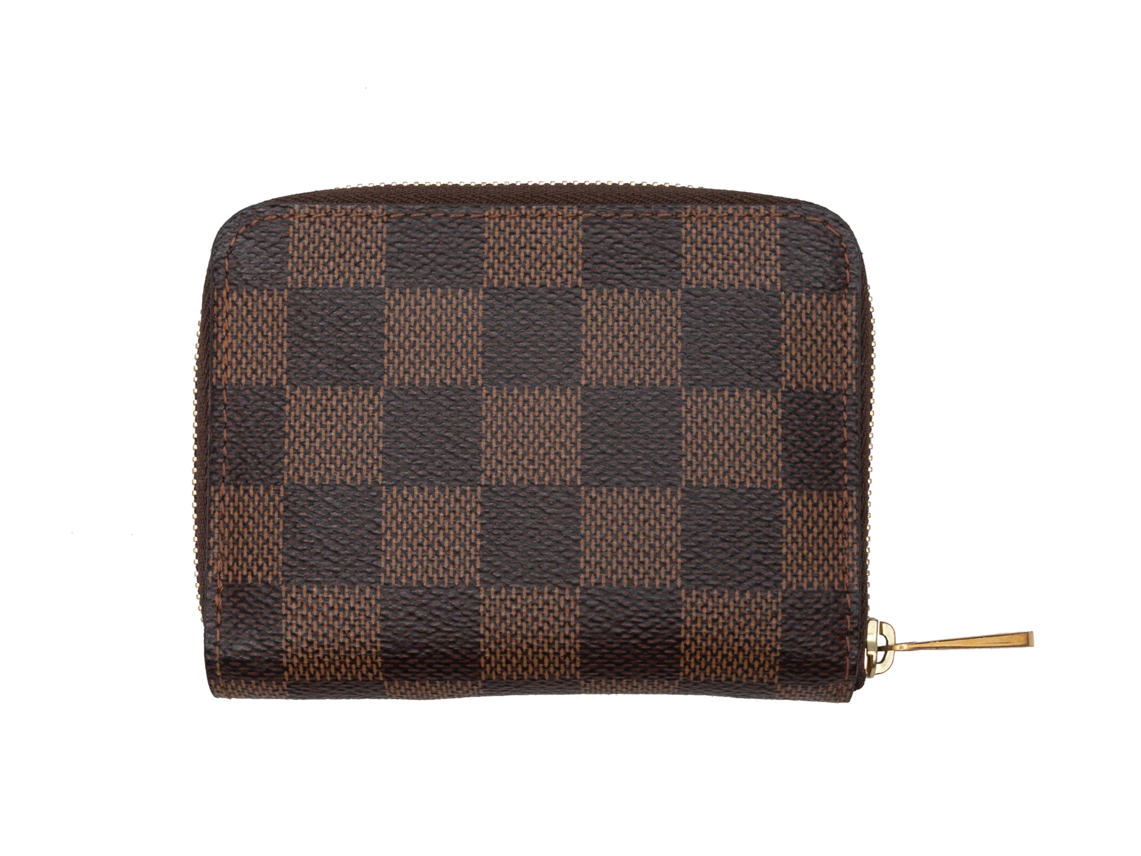 Brown Damier Ebene small zip wallet by Louis Vuitton. Gold-tone zip closure. 3.5