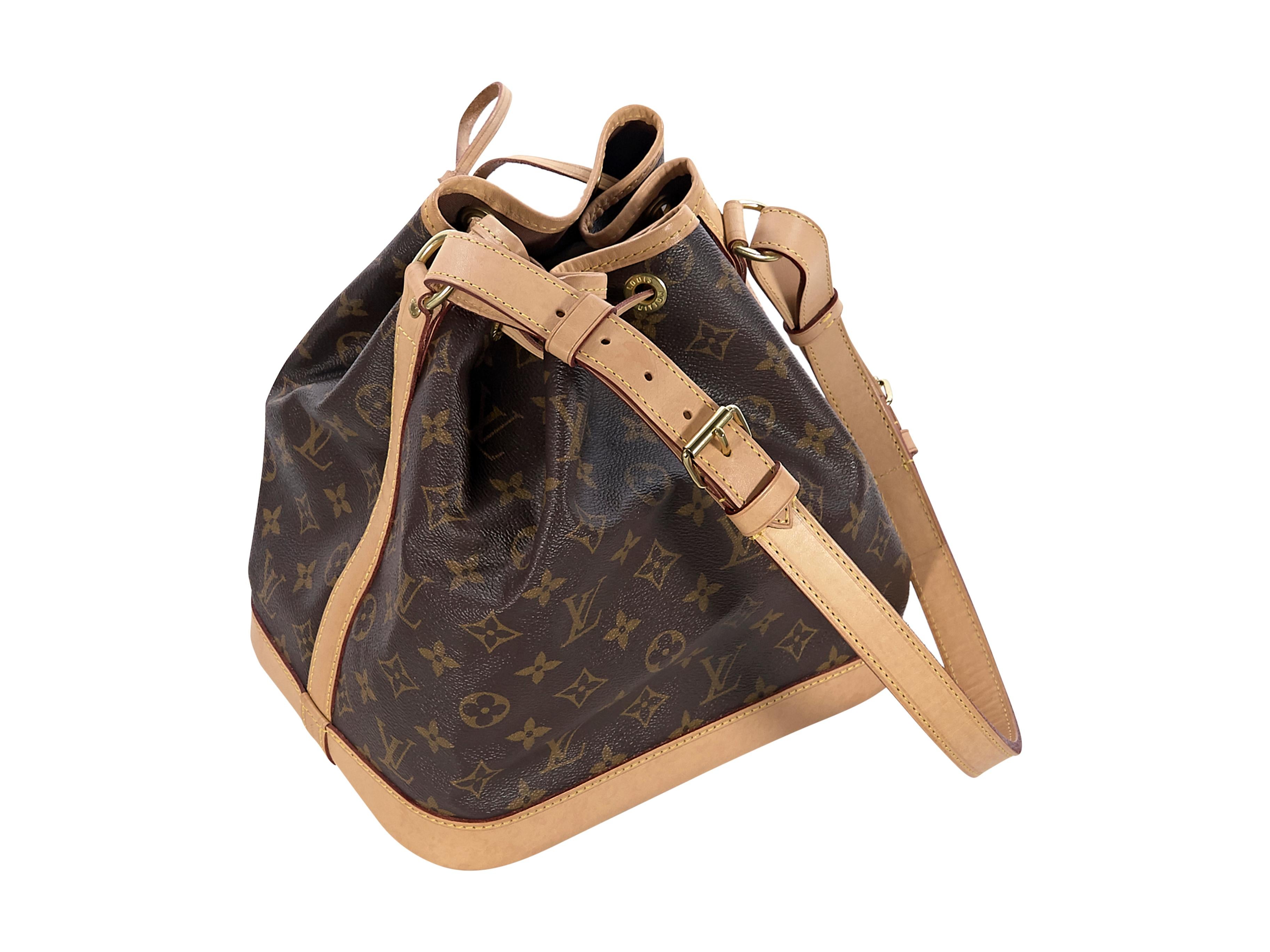 Product details:  Brown monogram coated canvas Noe bucket bag by Louis Vuitton.  Trimmed with tan leather.  Adjustable shoulder strap.  Drawstring top closure.  Lined interior.  Goldtone hardware.  15.5