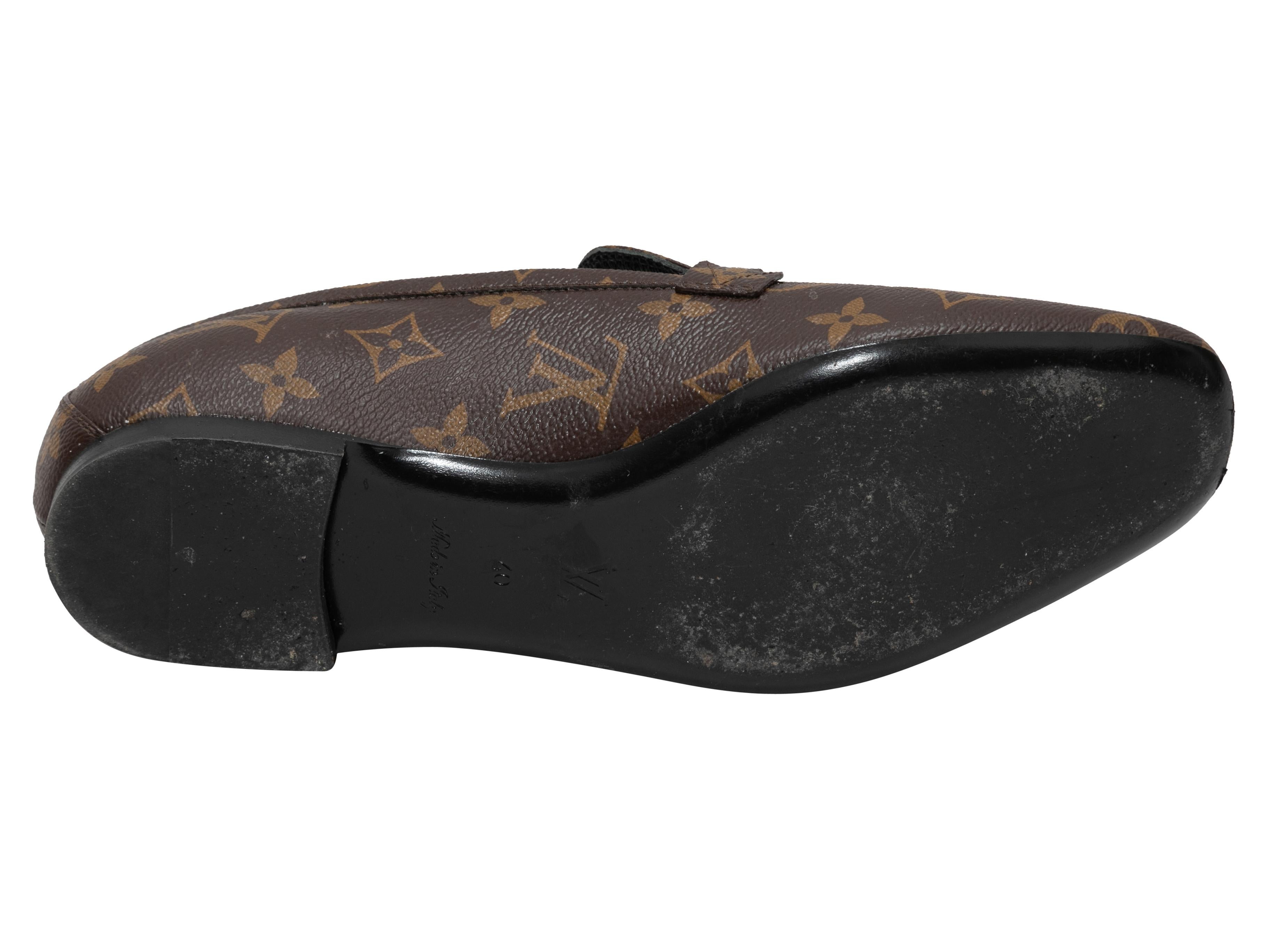 Brown monogram coated canvas Upper Case loafers by Louis Vuitton. Gold-tone hardware.