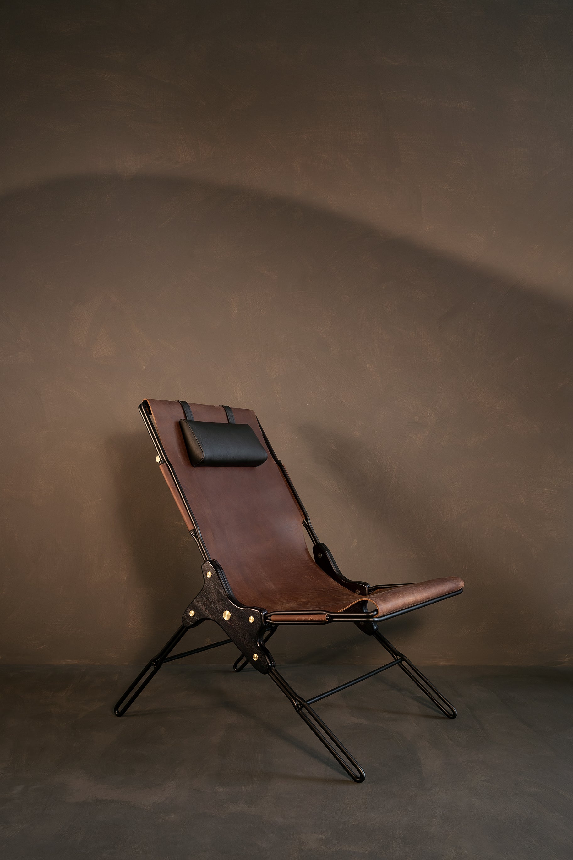 Brown lounge chair by Estudio Andean. 
Dimensions: W 56 x D 83 x H 93 cm
Materials: steel, bronze, wood, leather.

Lounge chair made of steel rod structure and solid colorado wood with a natural oil finish, Ecuadorian sustainable cowhide leather
