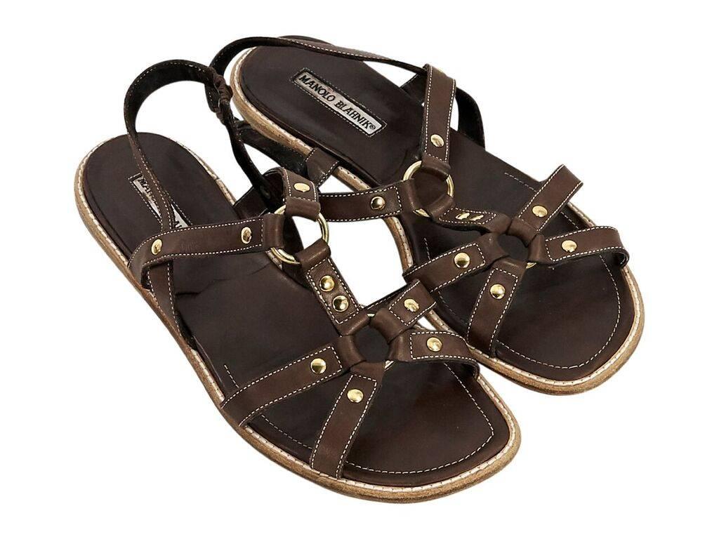 Product details:  Brown strappy leather flat sandals by Manolo Blahnik.  Studded accents.  Slingback strap with elastic panel.  Open toe.  Goldtone hardware.  Euro size 41.  Dust bag included.
Condition: Pre-owned. Very good. 
Est. Retail $ 295.00