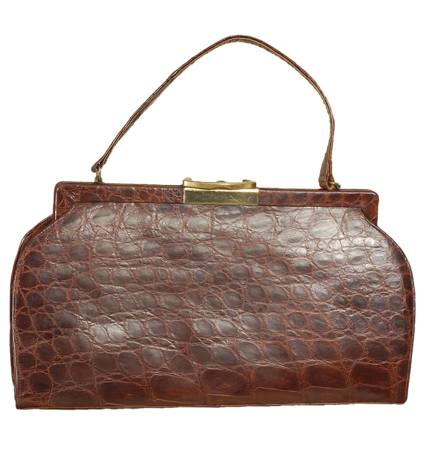 A ladylike staple accessory and a sign of good breeding, an alligator top handle bag remains as relevant today as it was a half-century ago. Pairs as effortlessly with denim and a trench as it does with a cocktail dress. This one has the very modern