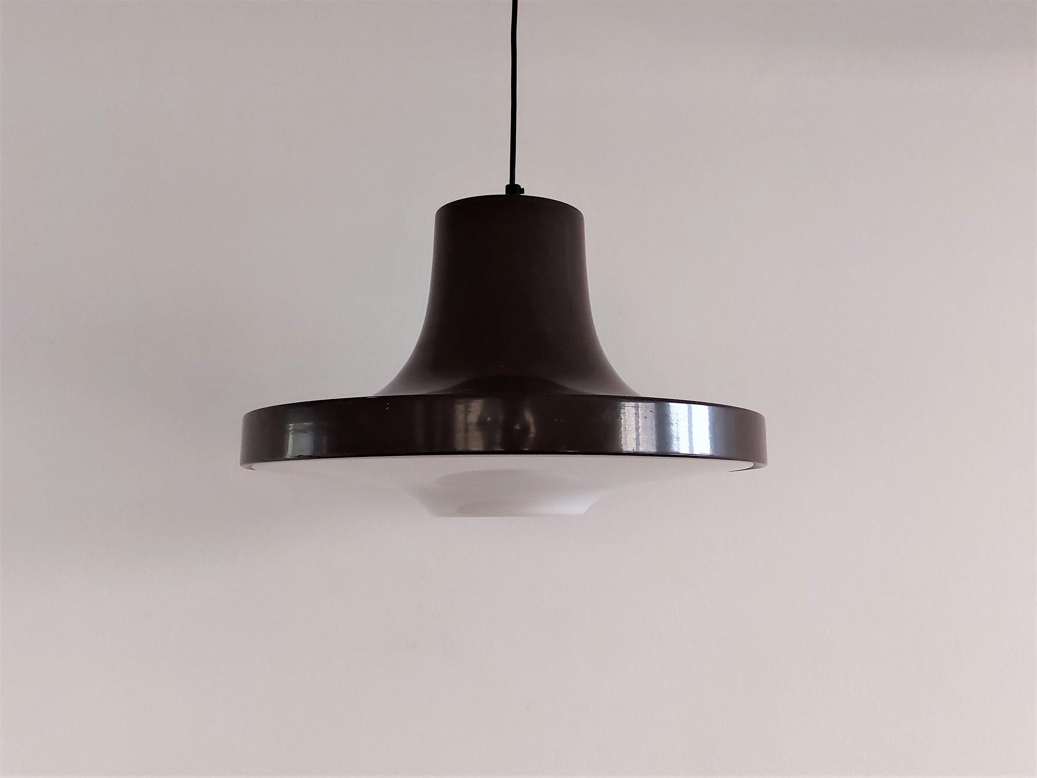 This pendant lamp, model 54070, was made by the Swedish manufacturer Ab Fagerhult in the late 1960's, earlier 1970's. It has a brown metal shade   with a perspex diffuser that gives a nice and soft light. This light is labelled in its ceiling cap.