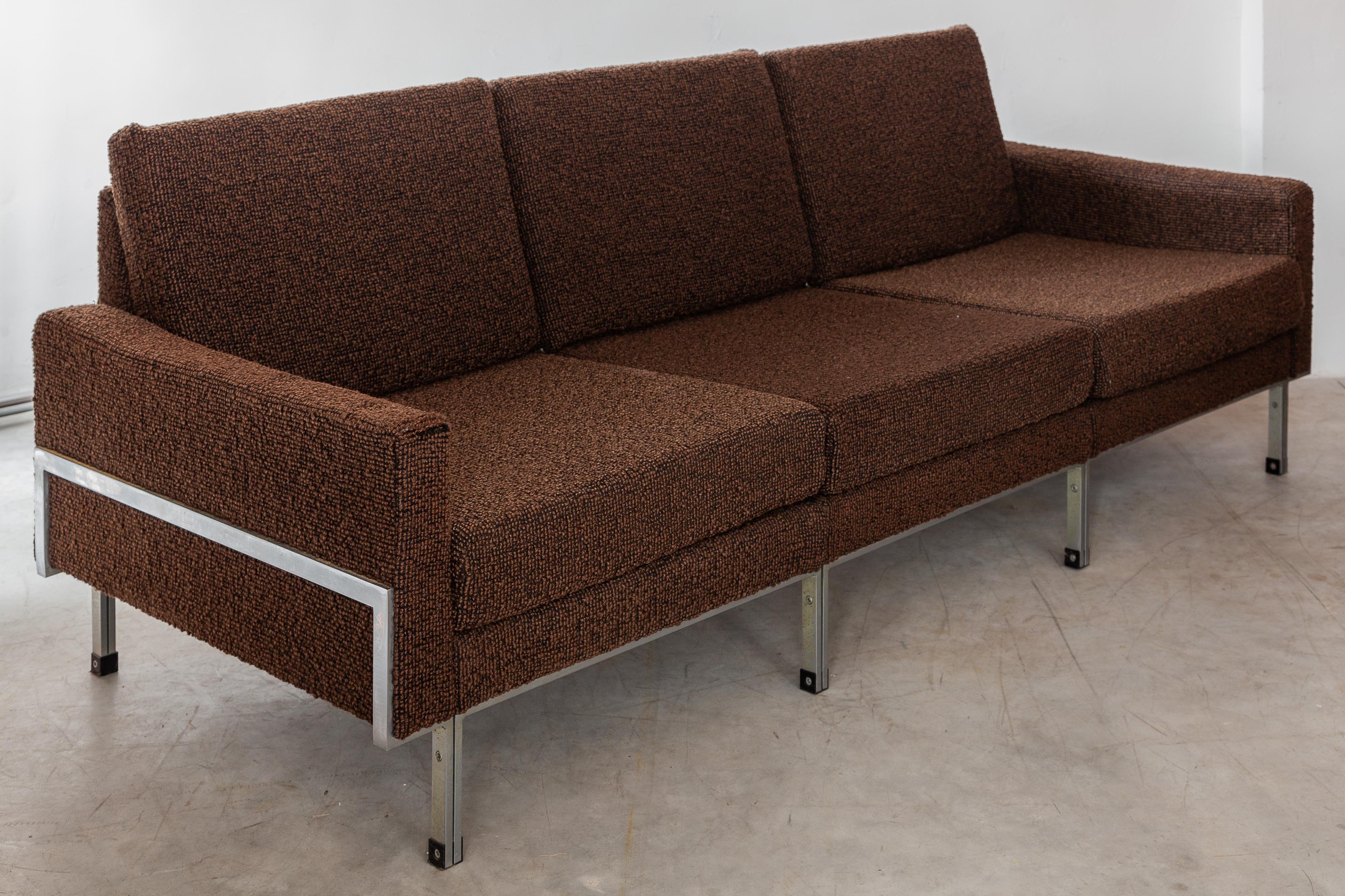 Original three-seat sofa in handsome textured brown wool upholstery on a sleek chrome frame. The sofa can be completely dismantled as a modular system of three chairs or a two-seater and one chair. The cushions can be used on both sites
Dimensions: