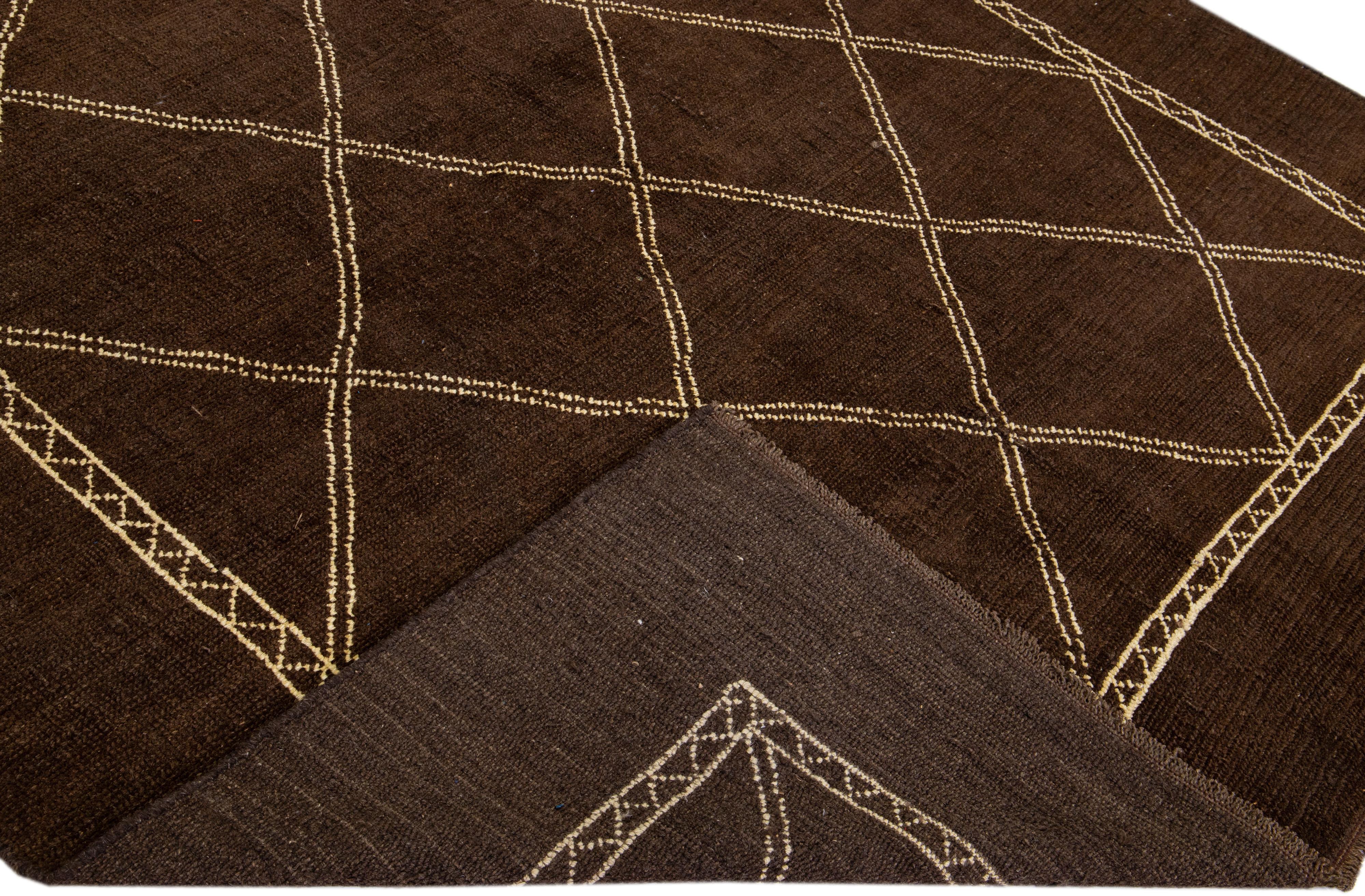 This Beautiful Moroccan-style handmade wool rug makes part of our Northwest collection and features a brown color field and beige accents in a gorgeous geometric tribal design.

This rug measures: 7'2