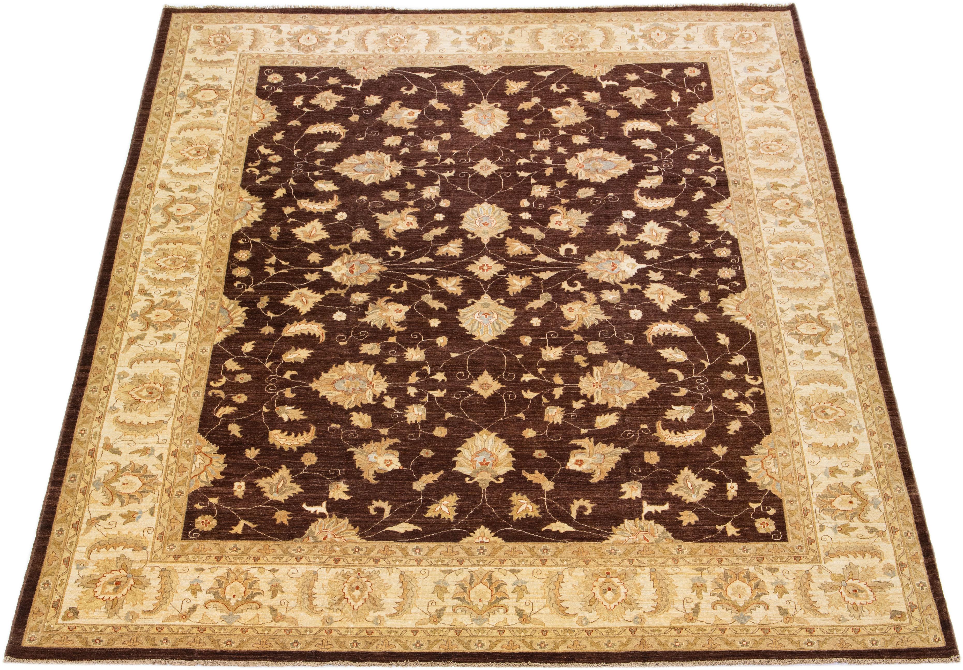 Beautiful Paki Peshawar hand-knotted wool rug with a brown color field. This modern rug has a beige and golden frame with green accents, a beautiful all-over Classic vine scroll, and a palmettes motif.

This rug measures: 12'4'' x 14'8