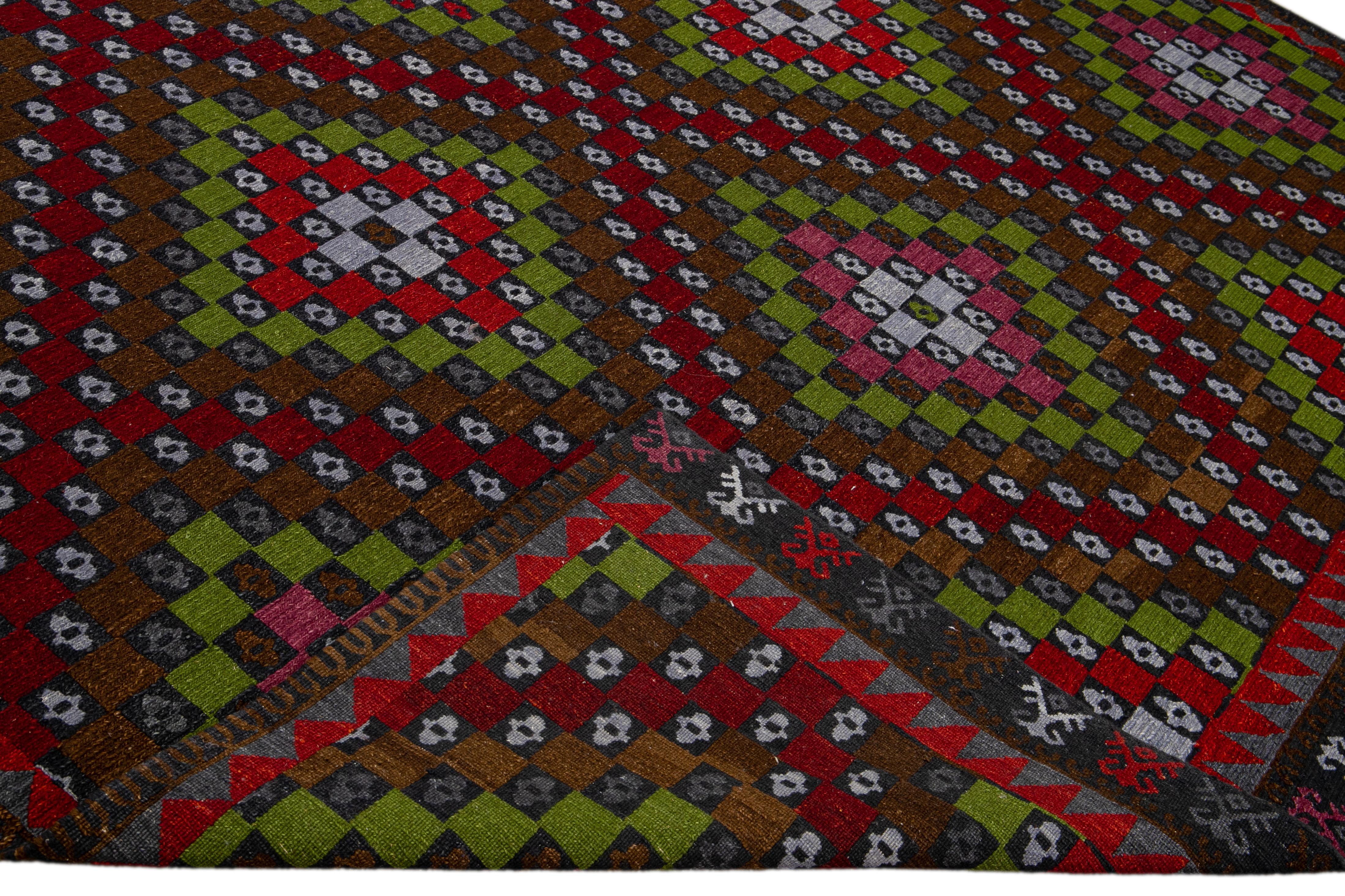 Beautiful Modern Soumak hand-knotted wool rug with a brown field. This piece has red, green, pink, and white accents in a gorgeous all-over geometric design.

This rug measures: 10' x 14'.

Our rugs are professional cleaning before shipping.