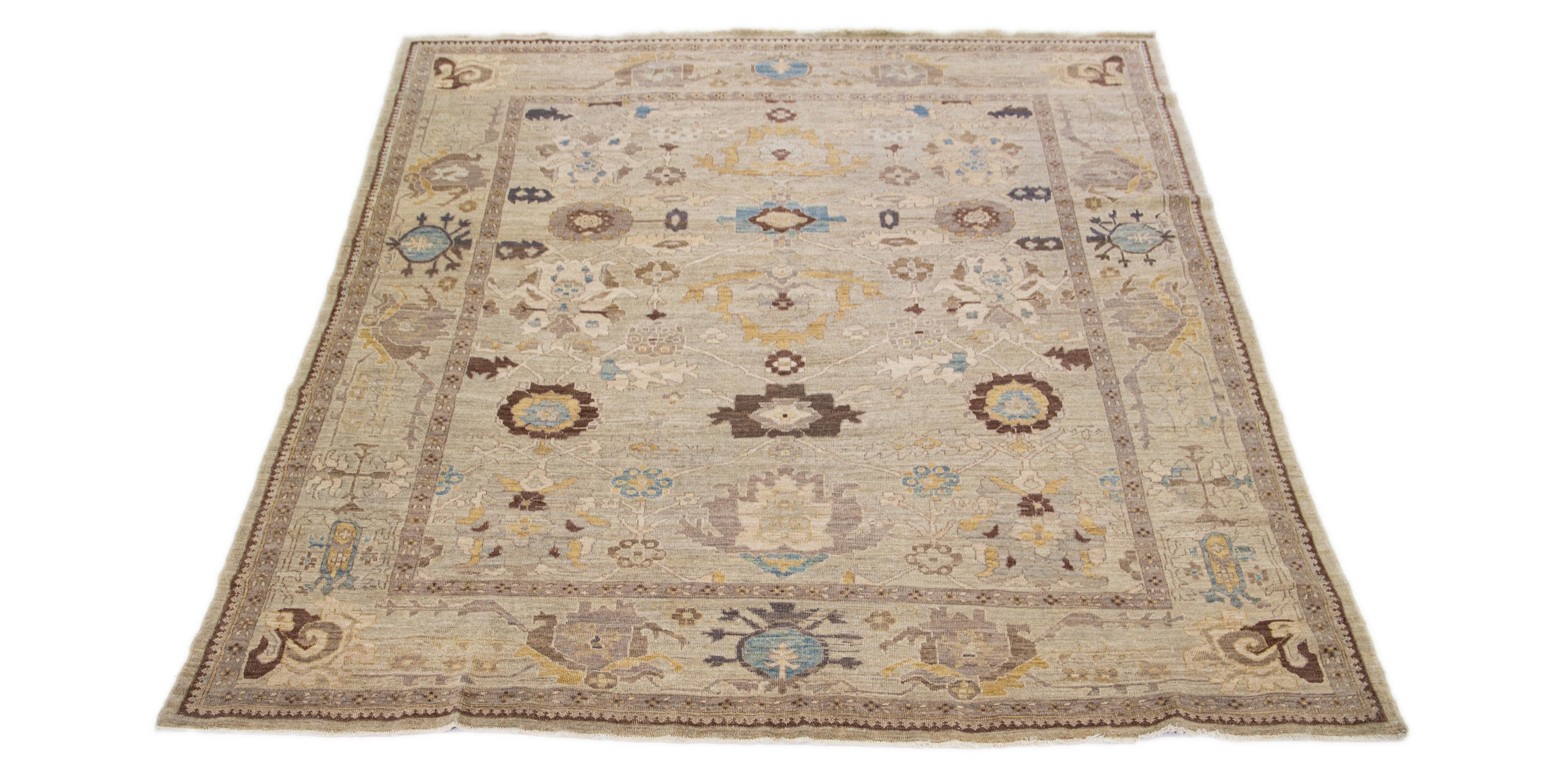 This modern reinterpretation of timeless Sultanabad design is beautifully manifested in a hand-knotted wool rug, resplendent in its striking light brown shade. An intricate border delineates its all-over floral embroidery, embellished with