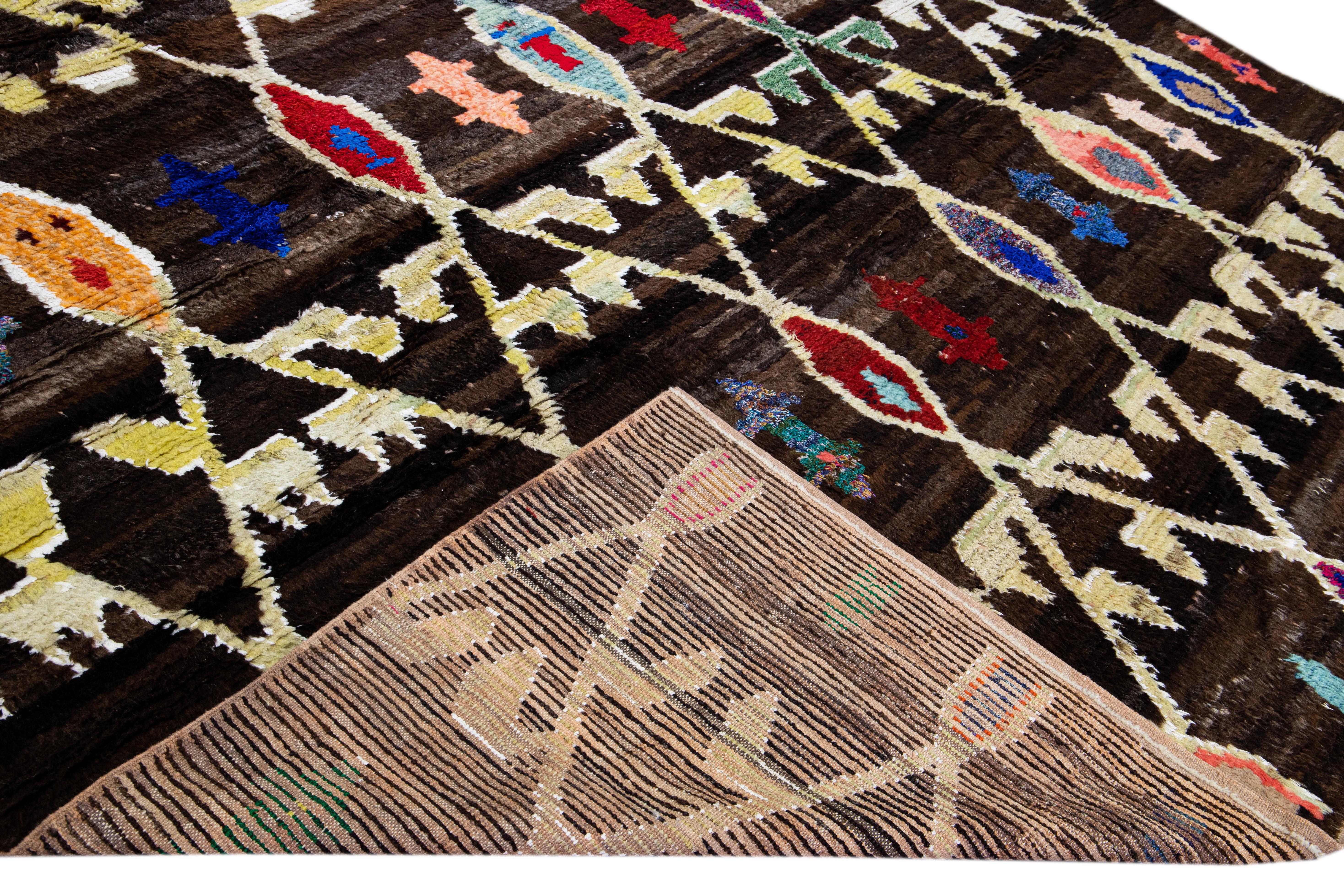 Beautiful Turkish Tulu handmade wool rug with a brown field. This Modern rug has multicolor accents features a gorgeous all-over geometric tribal design.

This rug measures: 10'3 x 12'9