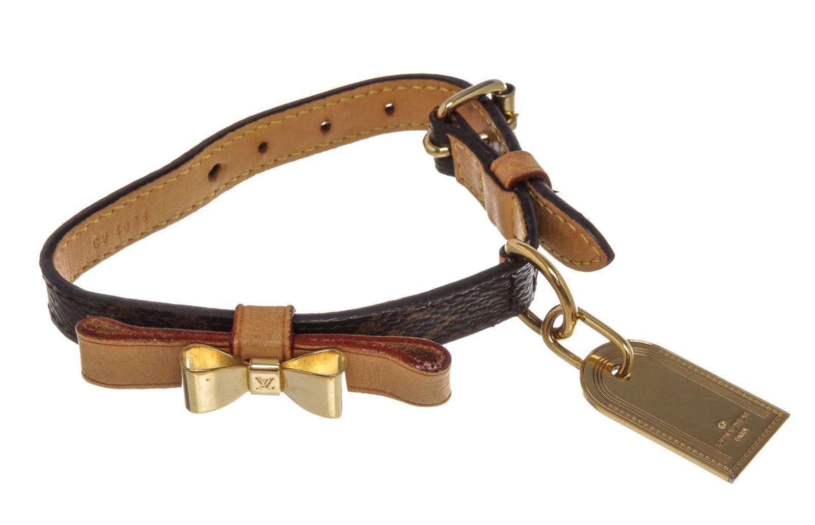Brown monogram canvas Louis Vuitton Collier Baxter collar feature bow ornament with gold-tone hardware, tan vachetta leather trim and leather lining.





 

53956MSC