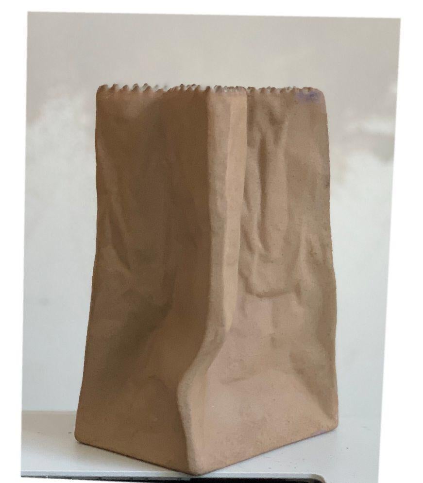 Rosenthal glazed white porcelain crushed paper bag vase sculpture

This iconic Rosenthal hallmarked brown porcelain crushed and crinkled paper bag sculpture and or vase or art object is signed on the bottom. Tapio Wirkkala for Rosenthal Studio