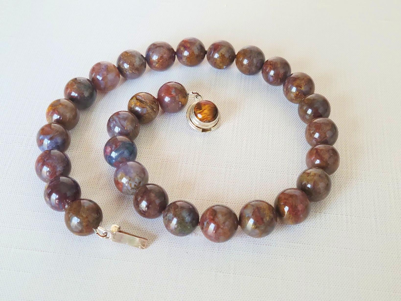 This beautiful necklace is crafted from natural pietersite, a rare gemstone known for its deep energy and unique color play.
Pietersite is a commercial term for a variety of the mineral chalcedony. Originating from Namibia and China.

The necklace