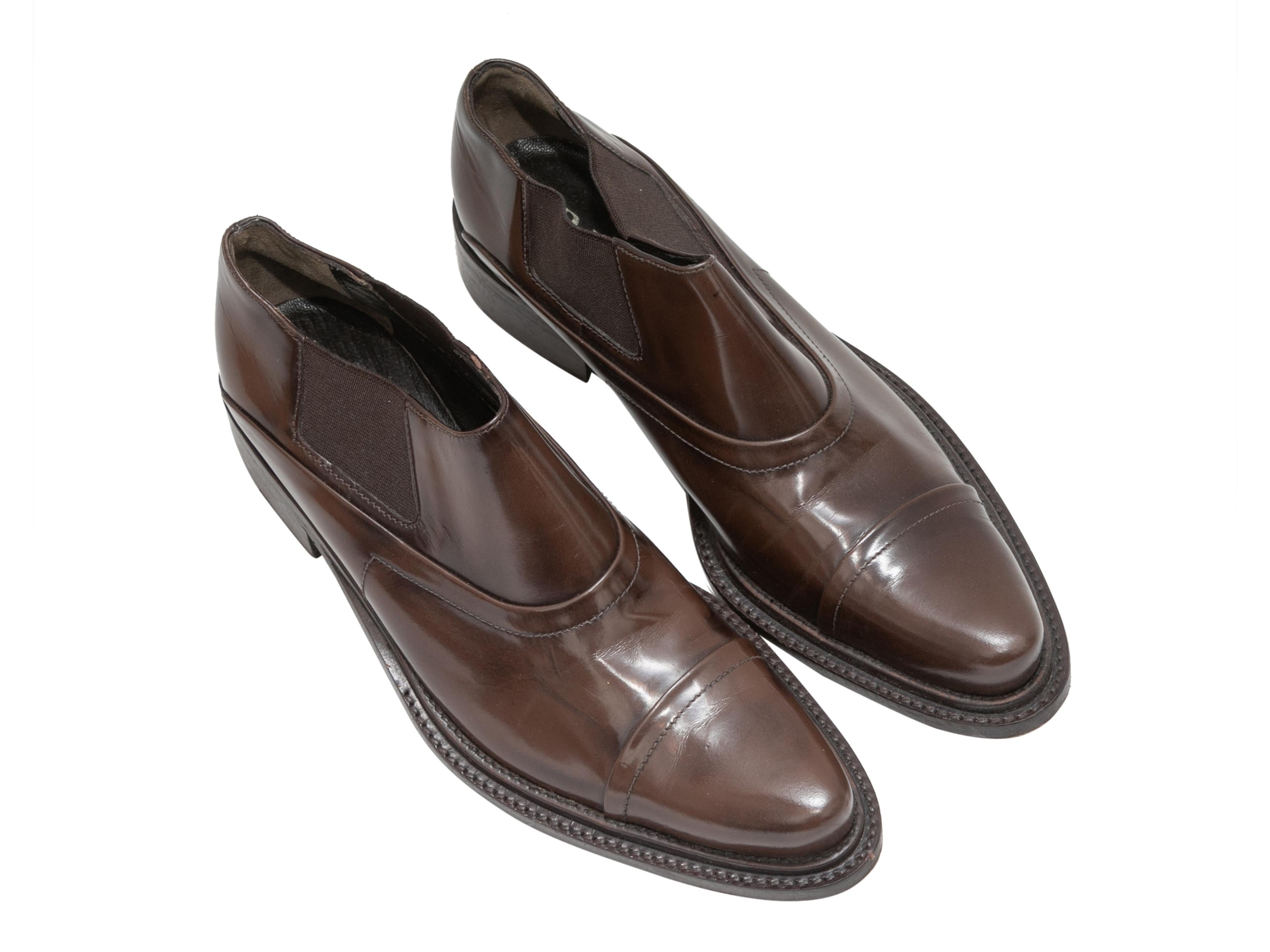 Brown leather dress shoes by Prada. Elasticized gores at sides. Stacked heels. 1.5