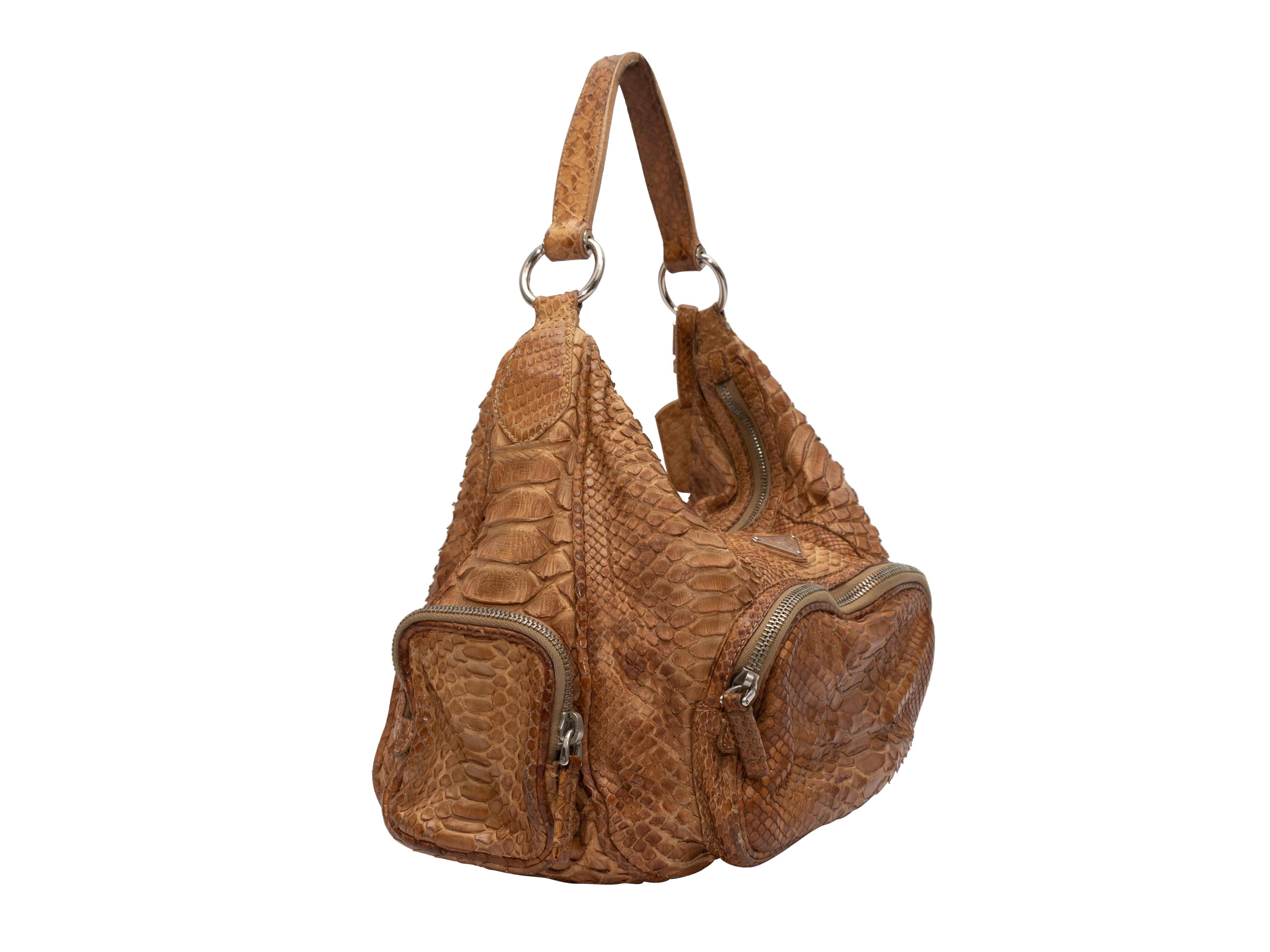Product Details: Brown Prada Python Hobo Bag. This bag features a python skin body, silver-tone hardware, three exterior zip pockets, a single shoulder strap, and a top zip closure. 12