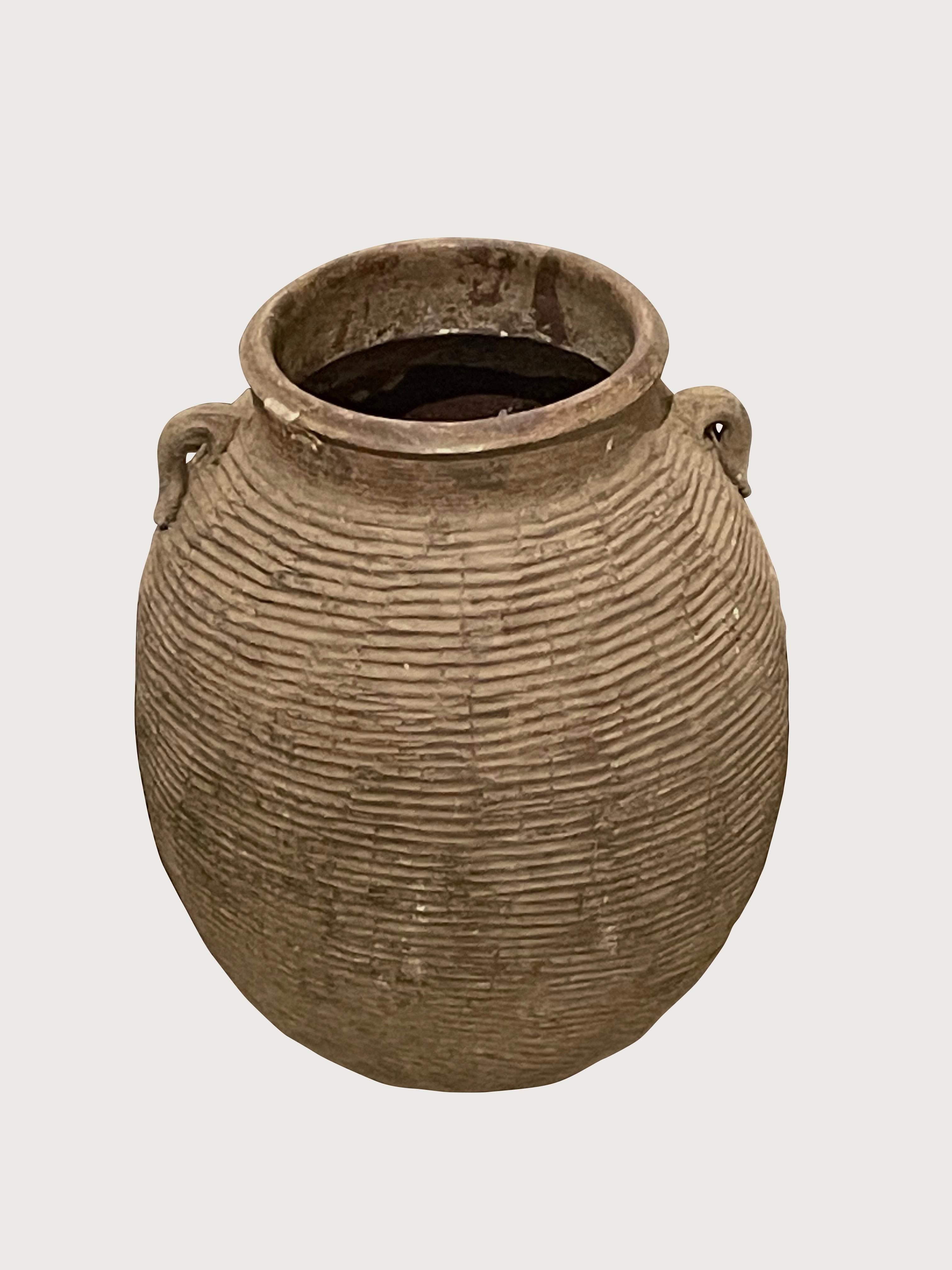 1940's Chinese horizontal rib textured vase with two small handles.
Weathered brown color.
Two are available and sold individually.