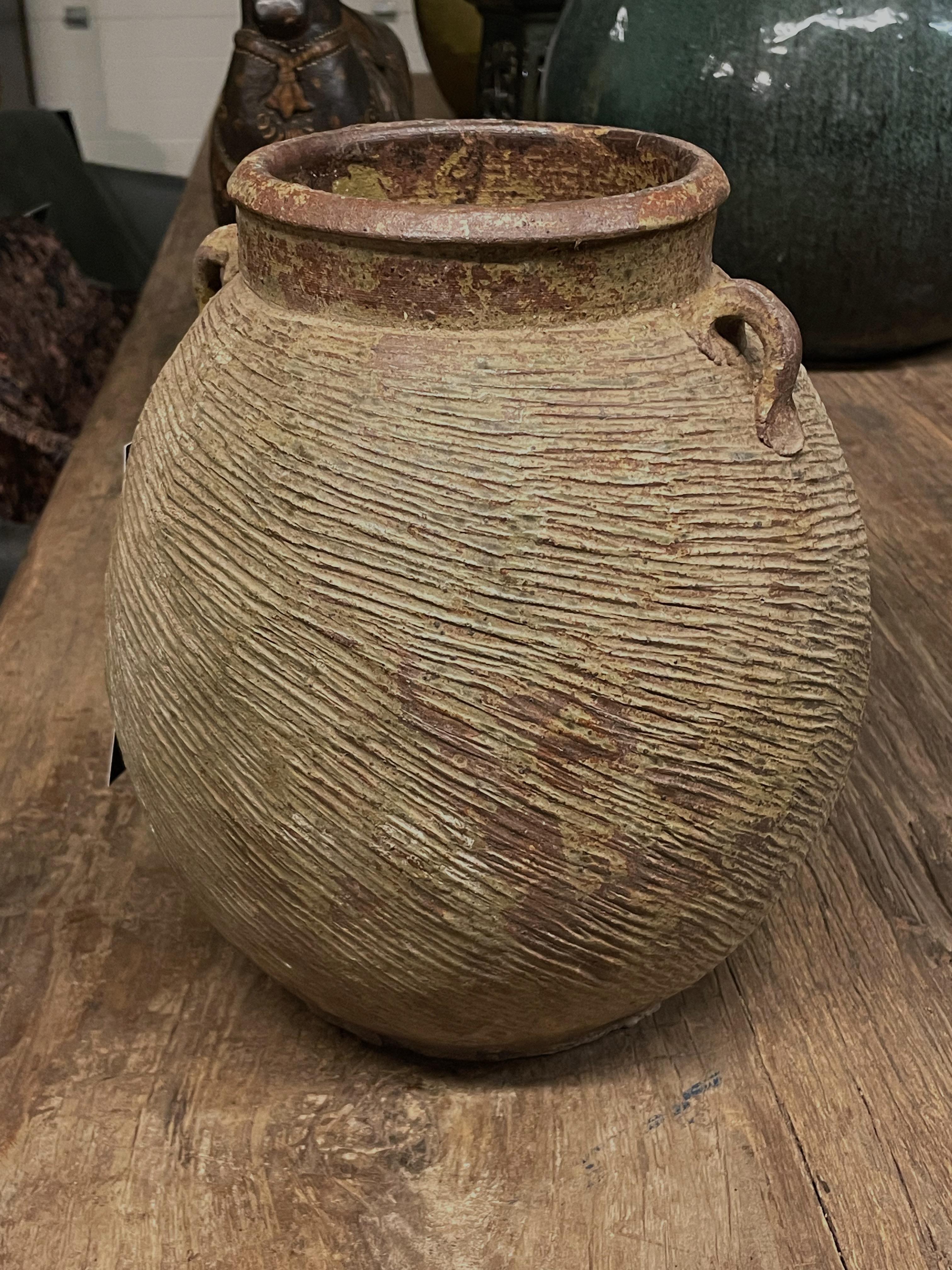1940's Chinese stoneware vase with raised rib texture.
Two small handles.
Originally used to store grains.
Three available and sold individually.
