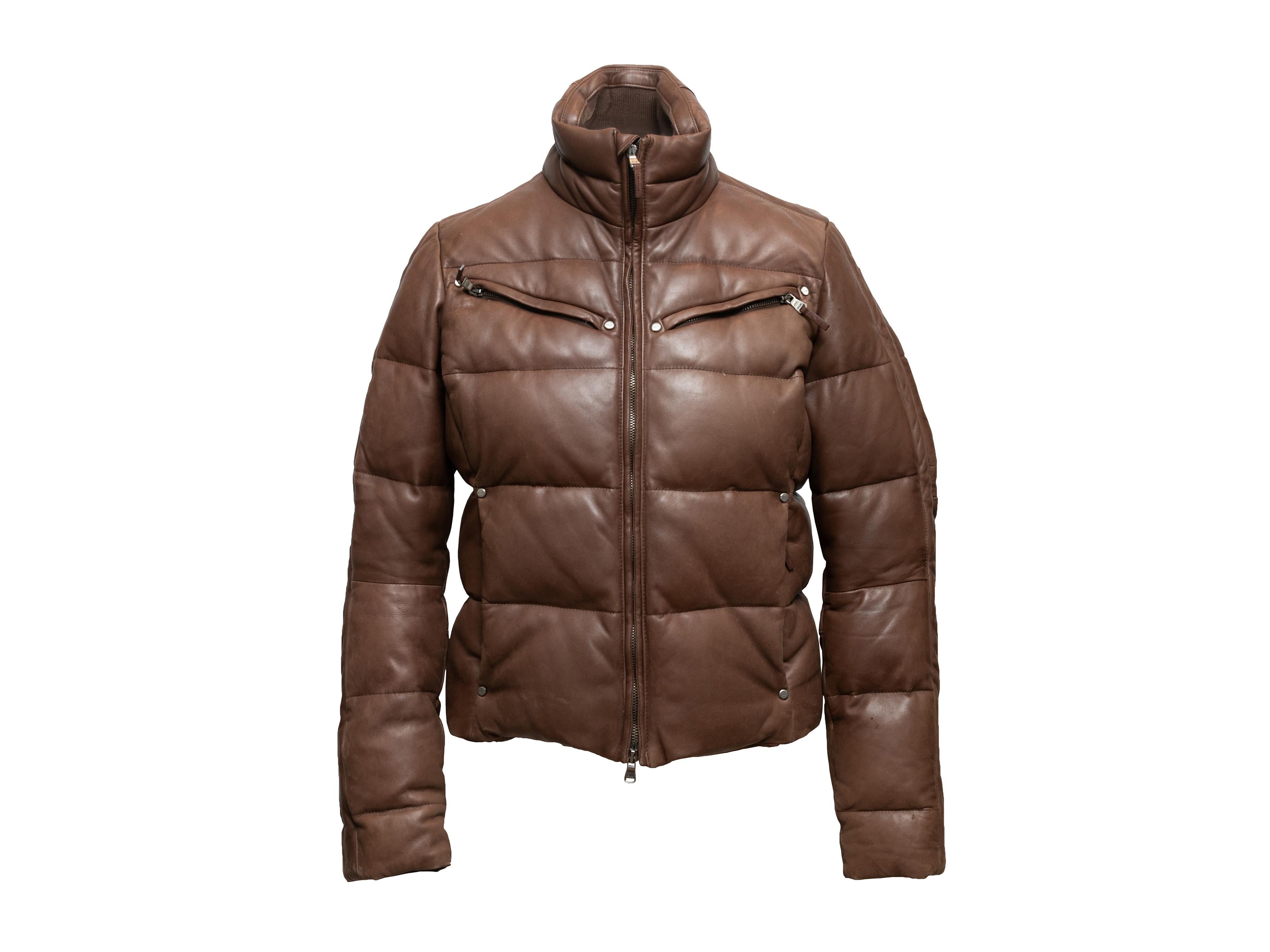 Brown leather down-filled puffer jacket by RLX Ralph Lauren. Stand collar. Four front pockets. Zip closure at center front. 36
