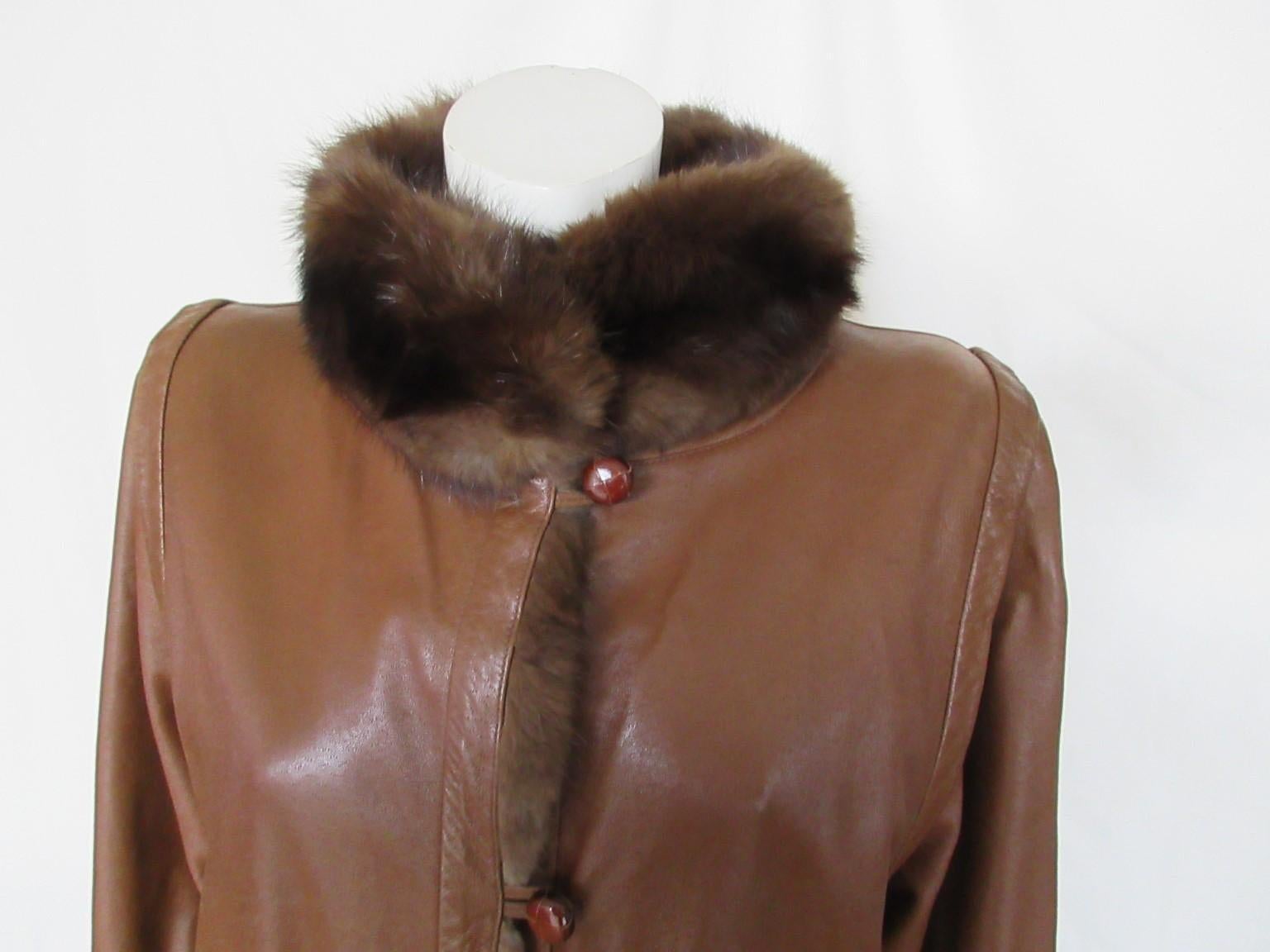 Brown vintage leather coat with sable fur lining , rare to find.

We offer more fur items, view our frontstore.

Details:
With 2 pockets
4 leather buttons
Body lining made from sable fur and sable cuffs
Condition : wear and tear of use
Size fits
