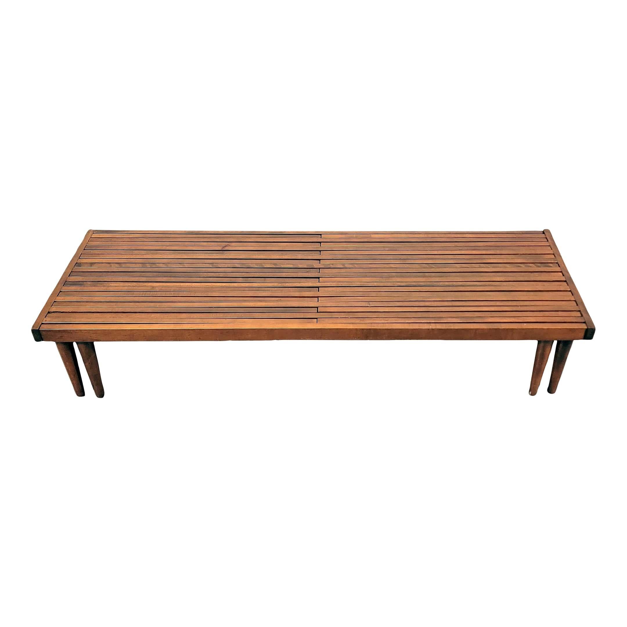 Midcentury Brown Saltman expandable slat bench designed by John Keal. This ingenious design has two ends that pull-out extending to almost 94” long. A versatile solid walnut bench, that can also be used as a coffee table. In very good vintage