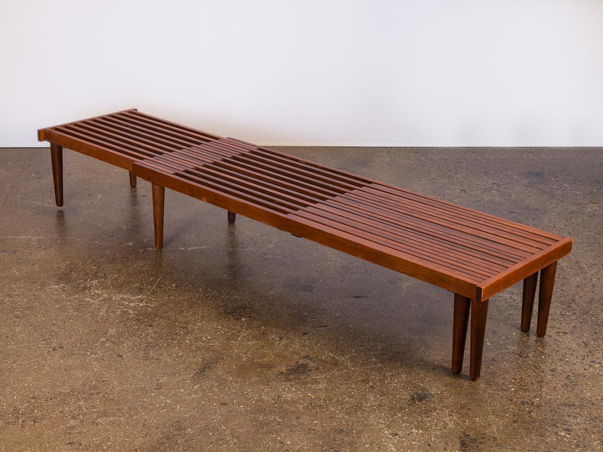 Midcentury Brown Saltman expandable slat bench designed by John Keal. This ingenious design has two ends that pull-out to extending to 96” long. A versatile bench, that can also be used as a coffee table. In very good vintage condition, strongly