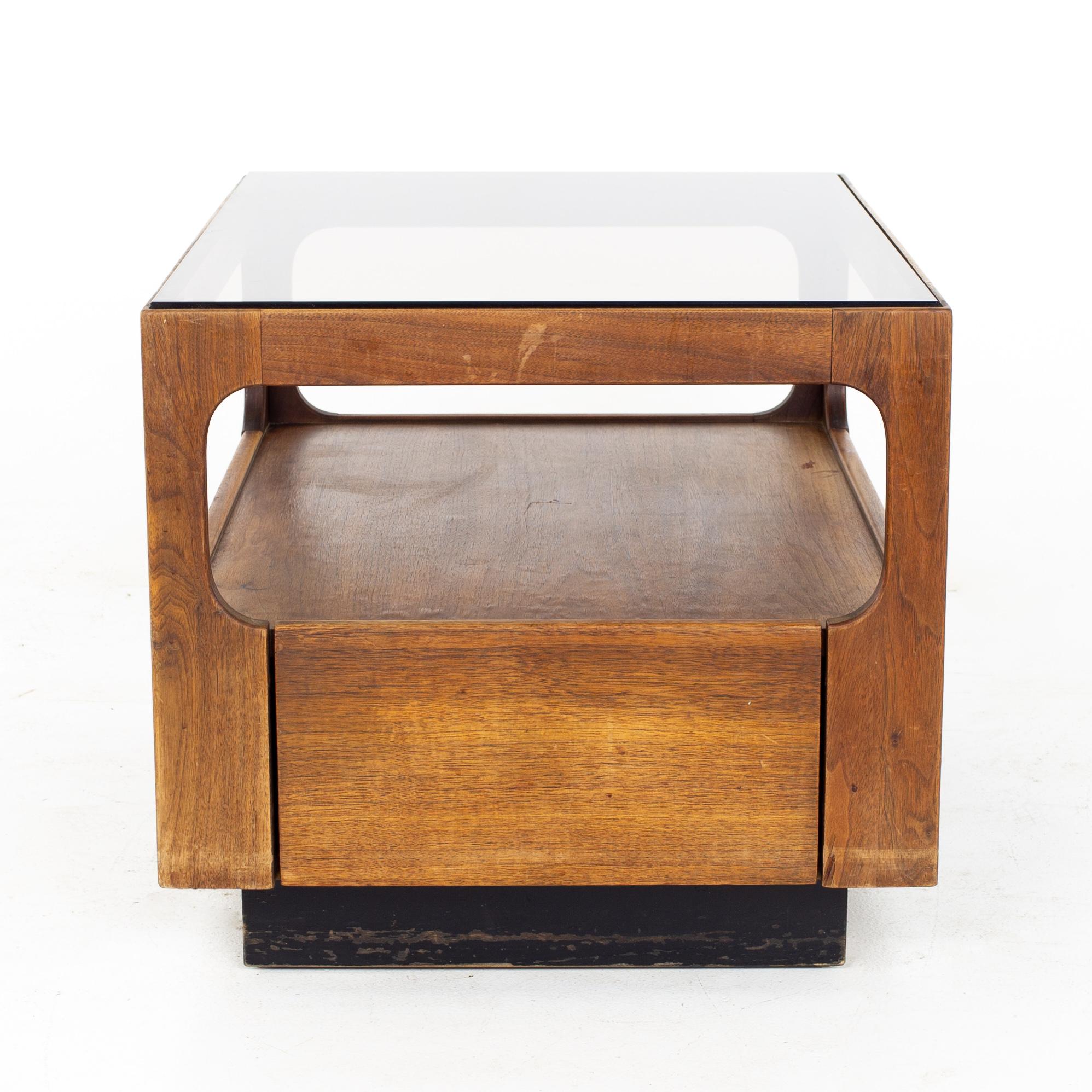 Brown Saltman Mid Century glass top side end table with drawer
Table measures: 27 wide x 20 deep x 18 inches high

All pieces of furniture can be had in what we call restored vintage condition. That means the piece is restored upon purchase so