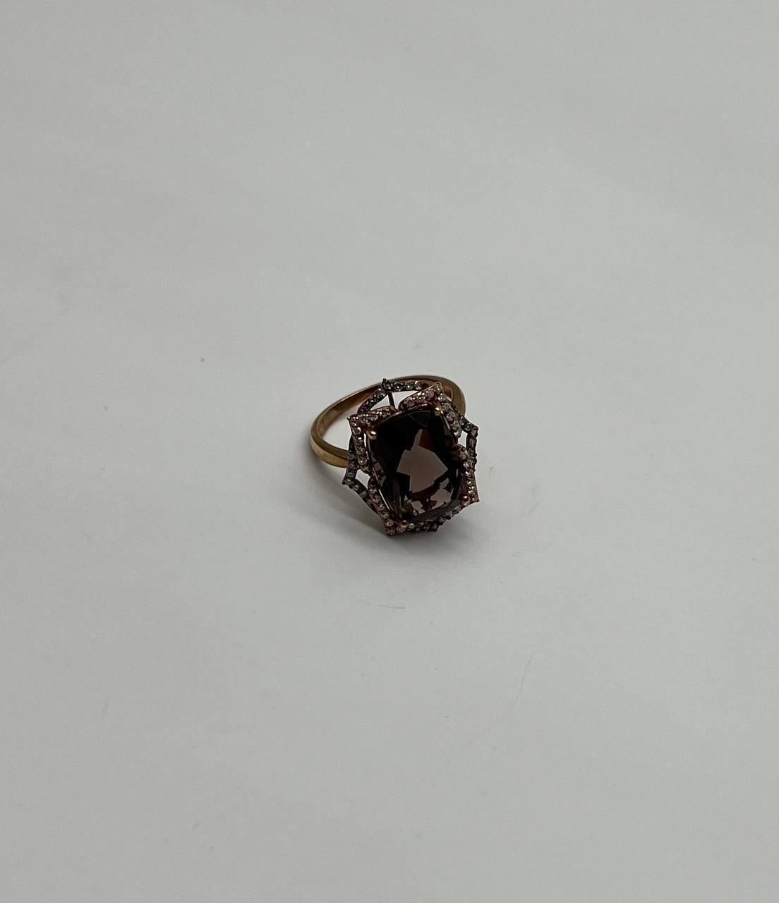 A striking Smoky Quartz and Diamond Ring, featuring a captivating dark brown smoky quartz set in a delicate gold band, adorned with intricate diamond accents in brown and white colors.
14K Rose Gold
0.31 CTW Diamonds
6.00 Cts Smoky Quartz
