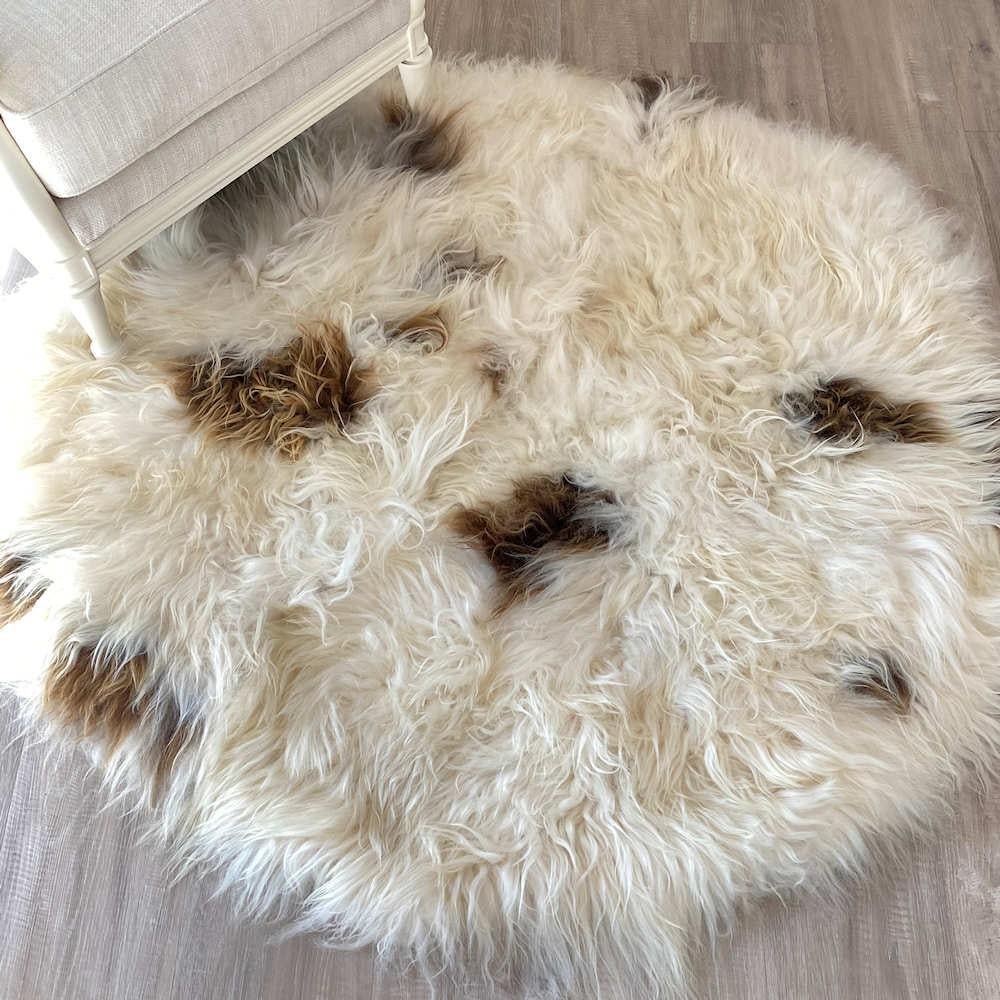 Add lush and inviting natural textures to a decor with this round, shaggy sheepskin rug. This enchanting shaggy rug features a long wool wile up to 5 inches length with exquisite natural brown spots in a delicious range of golden caramel