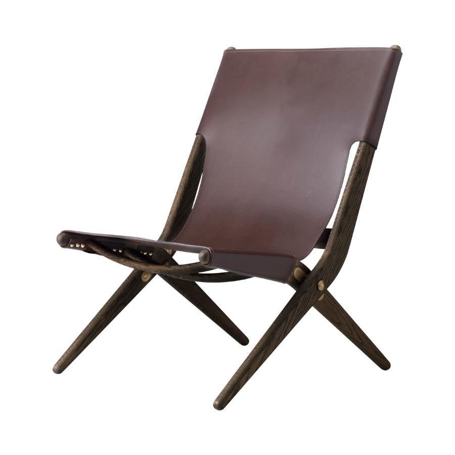 Brown Stained Oak and Brown Leather Saxe Chair by Lassen
Dimensions: W 60 x D 67 x H 84 cm 
Materials: Leather, Oak.

Mogens Lassen was perceived as ‘the naughty boy in class’, but he aimed for perfection in each design project. His eye for