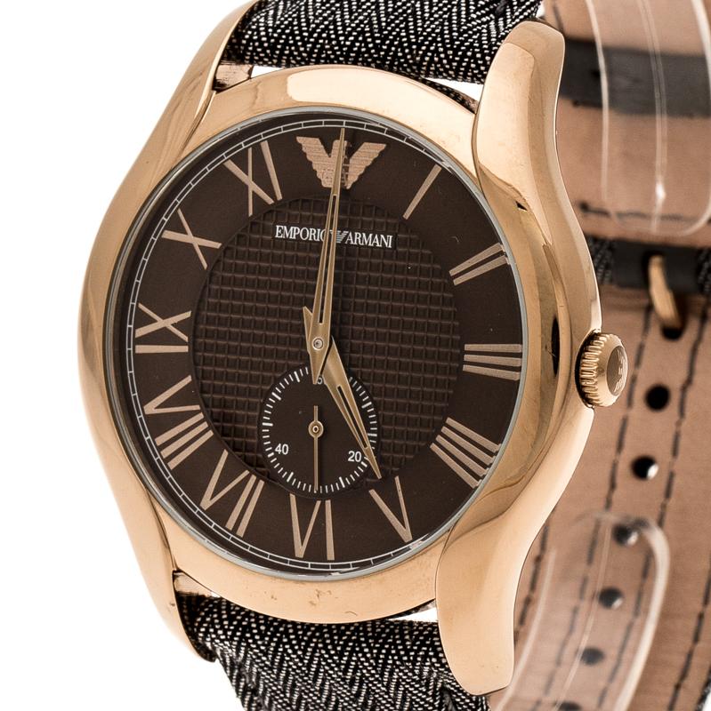 This timepiece is a unique creation for the modern man. Crafted from bronze PVD coated stainless steel, it features a round case with a textured brown dial housing two arms and Roman numerals. The subdial enables its chronograph capabilities. The