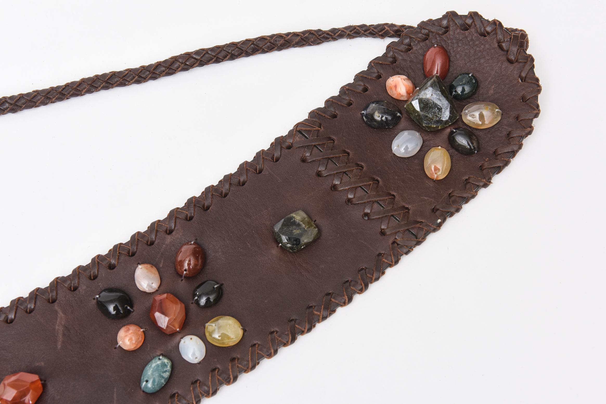 This gorgeous never used brown stitched leather tie belt has assorted cluster of beautiful agate stones in different colors. There are dimensional and raised.  The colors are varied and are in hues of orange, light yellow, shades of green, black,