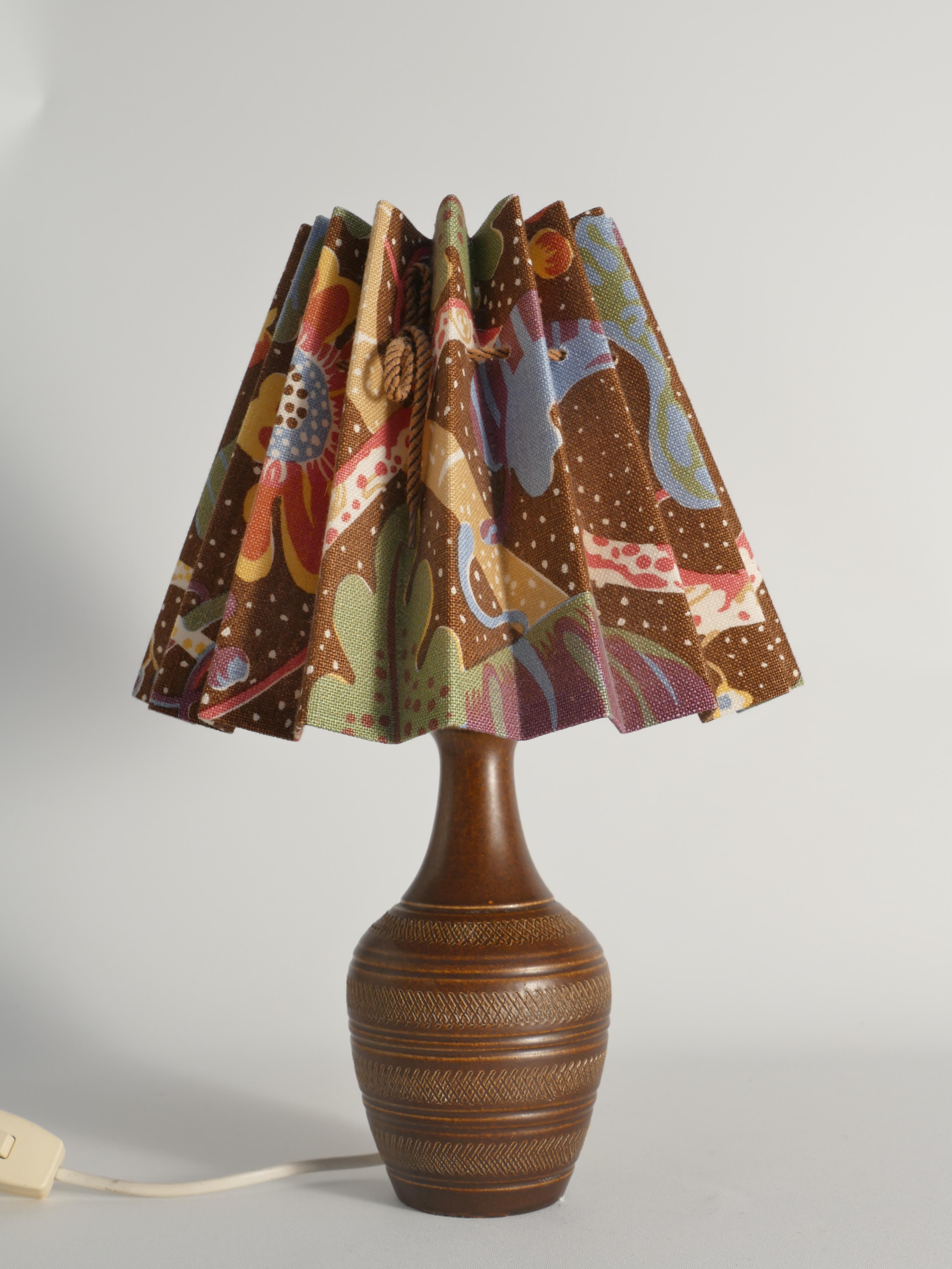 This very rare mid-century modern table lamp is a classic example of West German pottery by Scheurich, dating from the 1960s. It features a bold, sculptural ceramic base with a rich, earthy brown glaze characteristic of the era's fat lava and