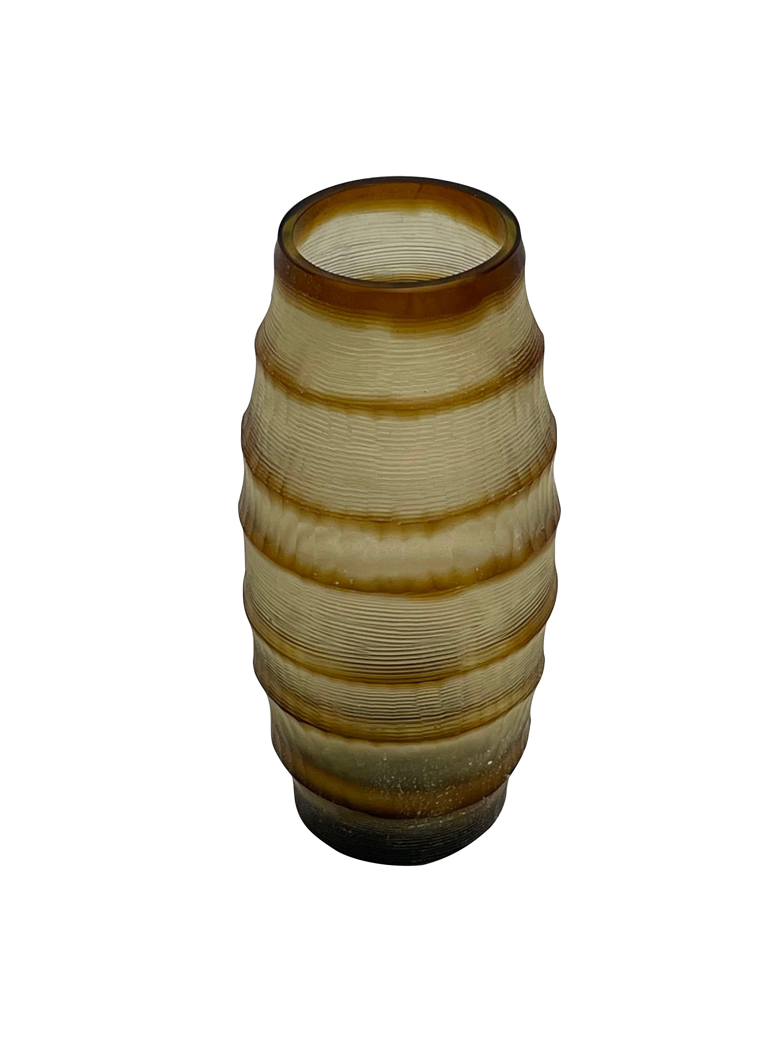 Contemporary Romanian horizontal ribbed and striped brown glass vase.
Tall cylinder shape.
Sits well with taller version S6114.
