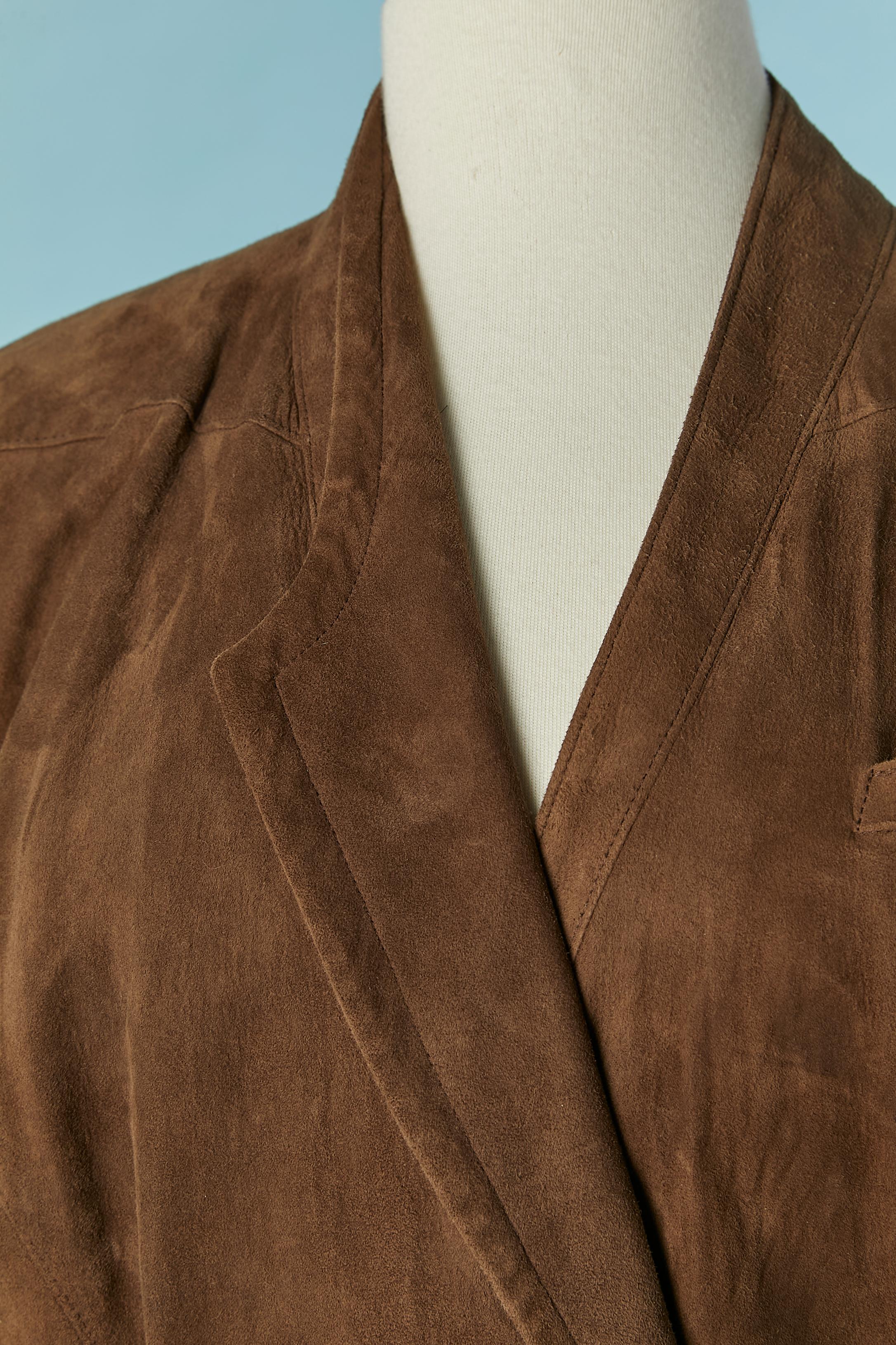 Brown sued wrap dress with belt and snap closure. No composition tag for the lining but probably rayon or acetate. One pocket on the top left. Belt with buckle and belt-loop. Snap (covered in the same suede) closure on the front waist and on the