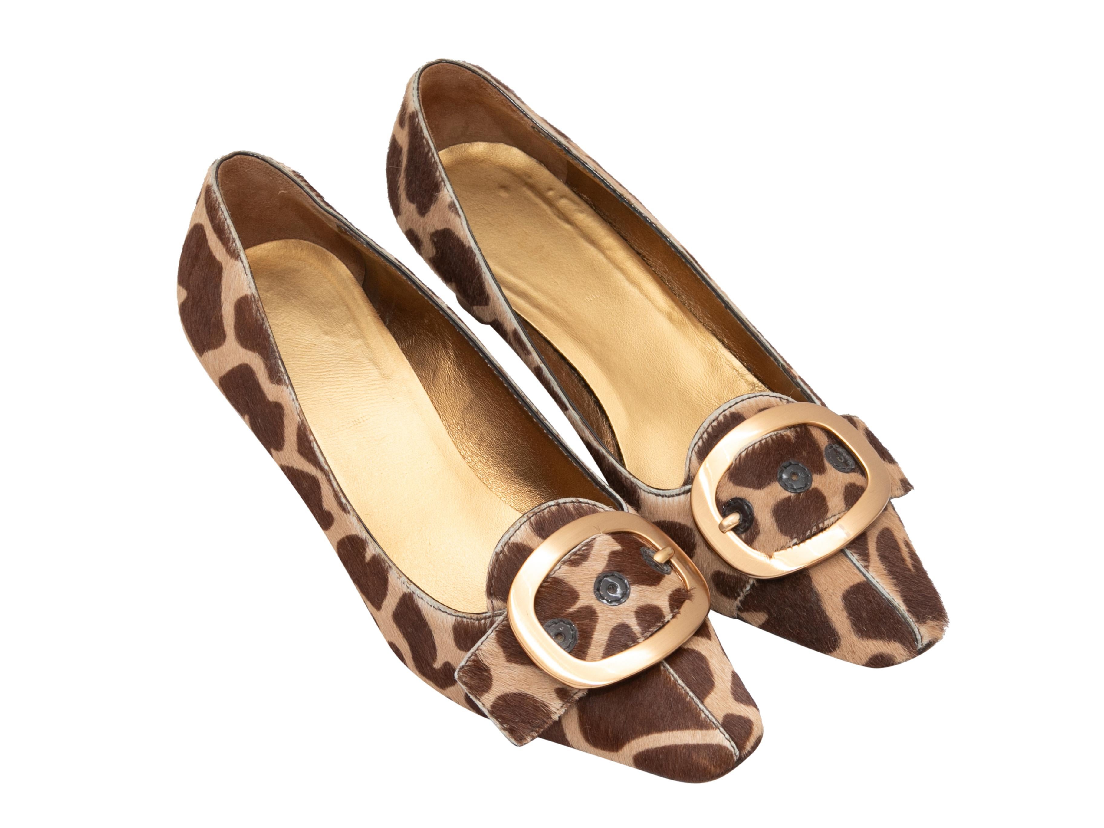 Brown and tan pointed-toe ponyhair animal print pumps by Prada. Buckle accents at tops. 1.75