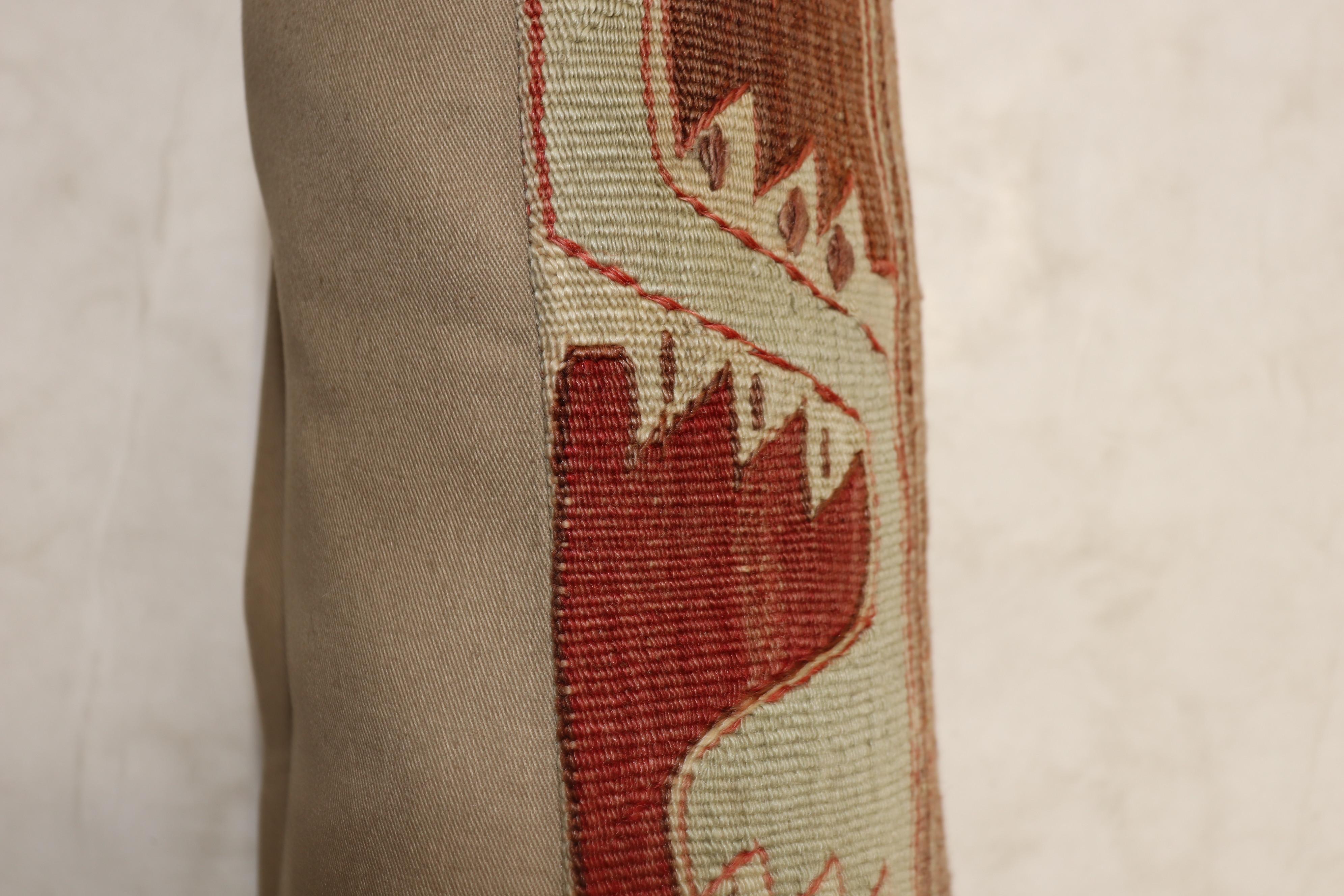 Larger bolster size pillow made from a vintage Turkish Kilim flat-weave.

Measures: 16” x 34”.