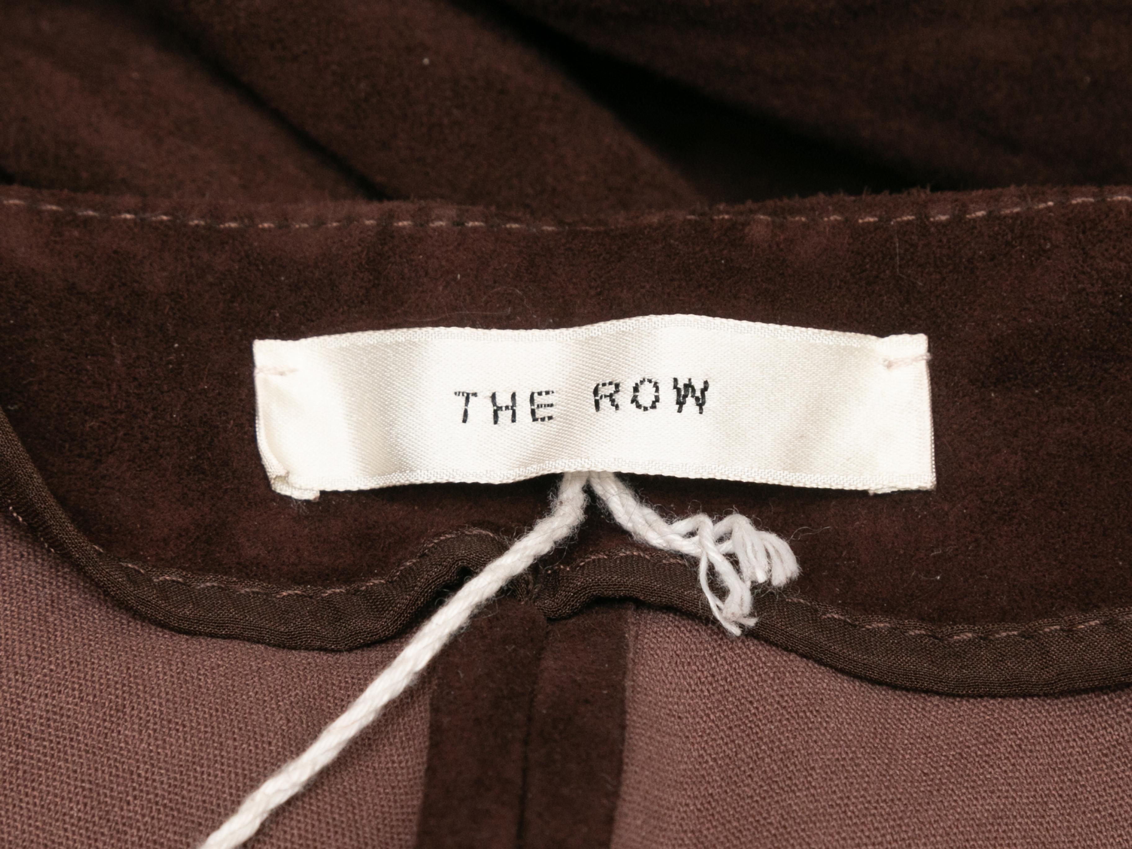 Brown skinny-leg suede pants by The Row. Side closure. 30